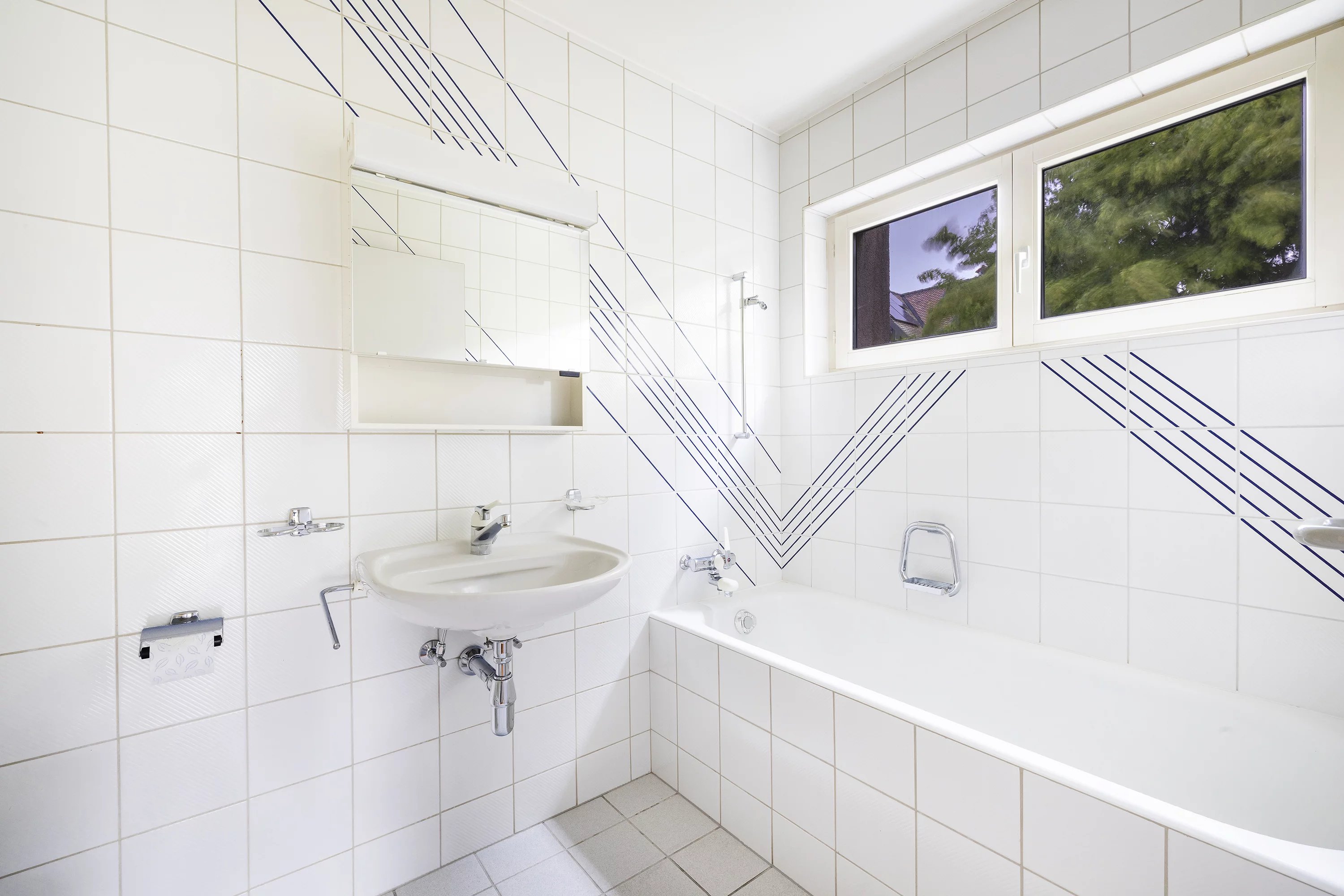 Helles Badezimmer mit Badewanne und Waschbecken