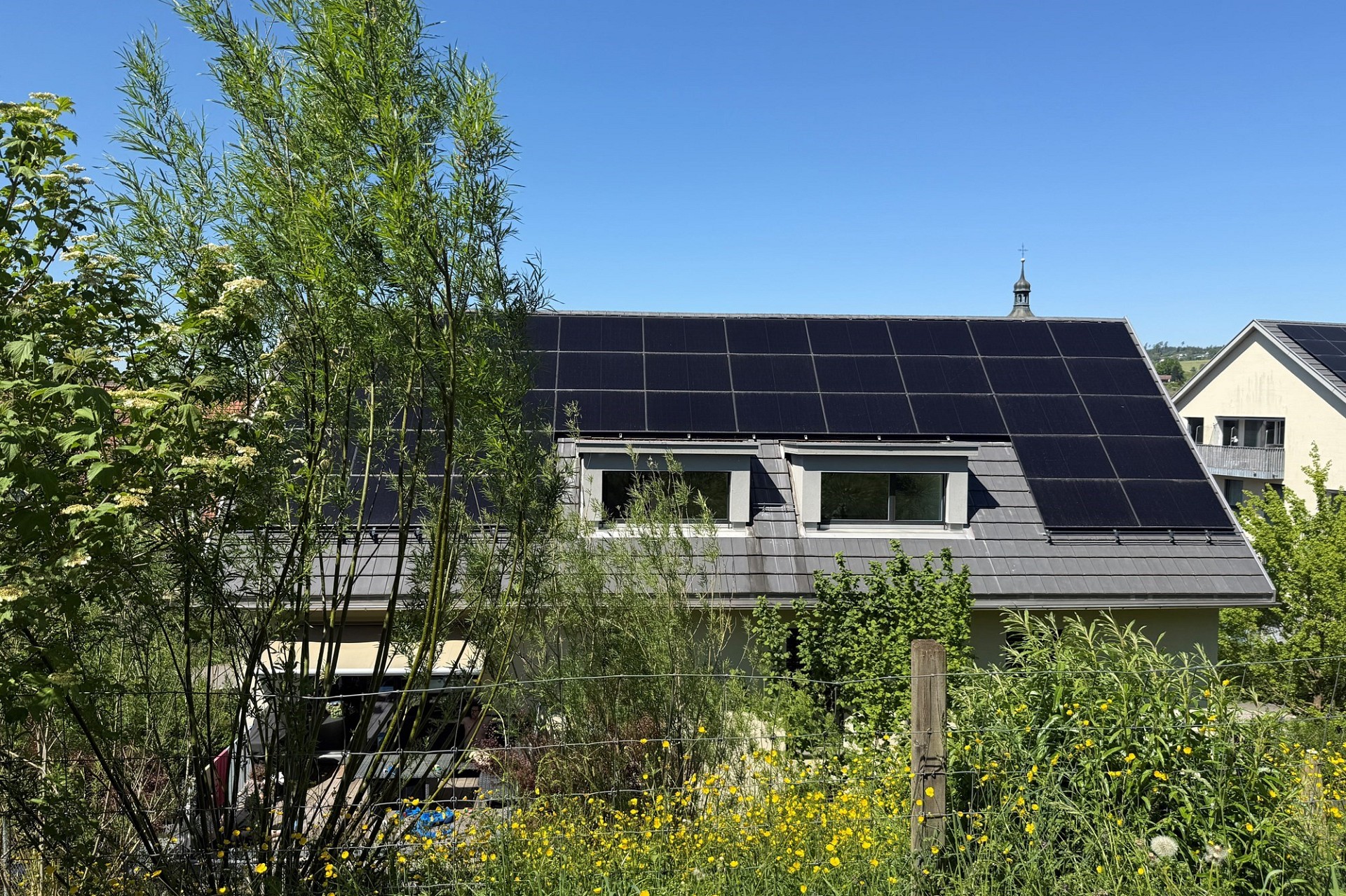 Haus mit großer Solardachfläche und Garten