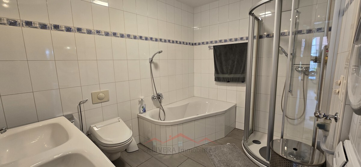 Helles Badezimmer mit Badewanne und Dusche