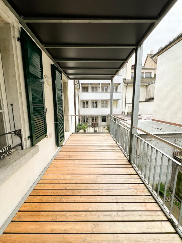 Überdachter Balkon mit Holzdielen