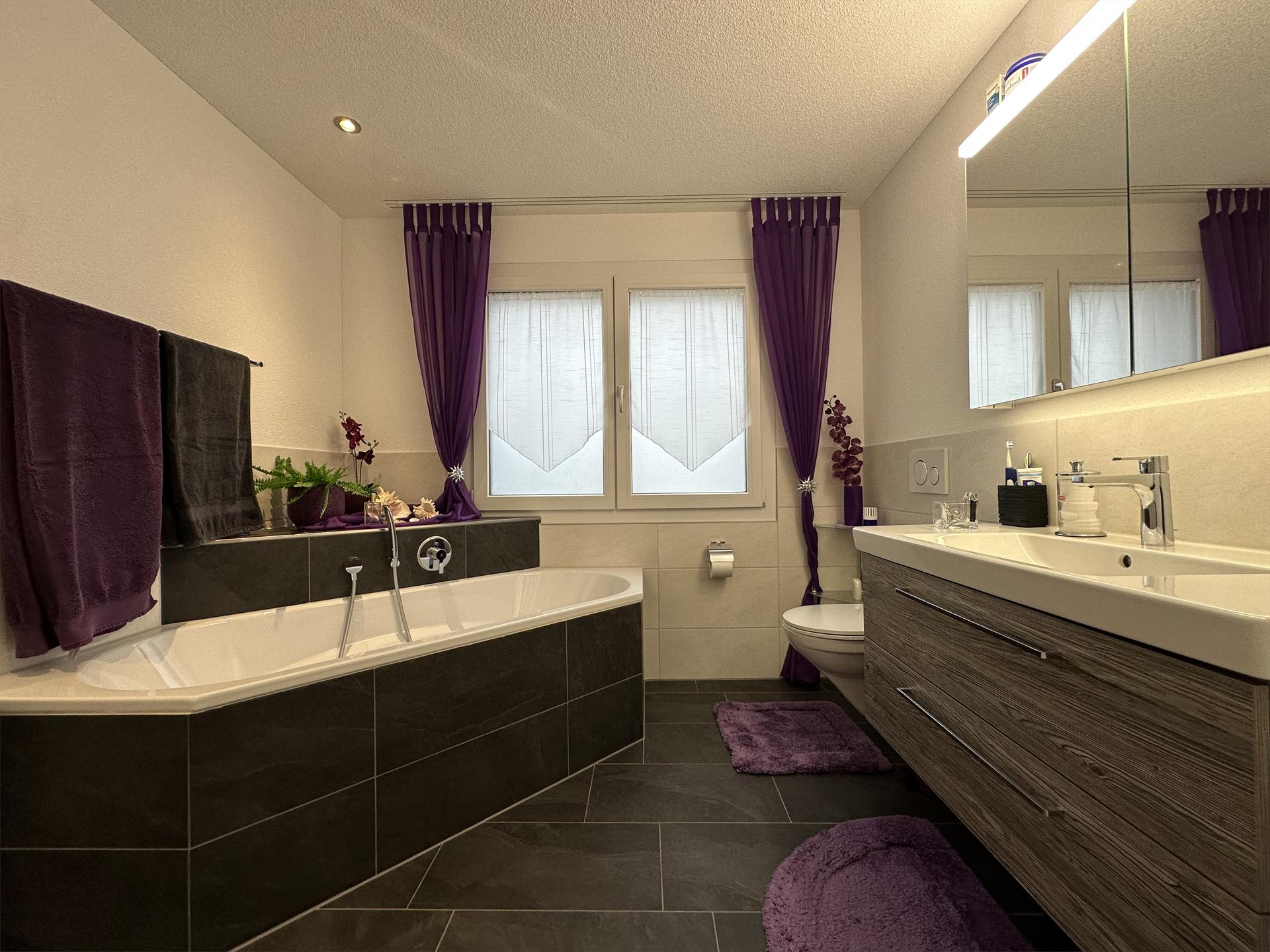 Modernes Badezimmer mit Badewanne und Doppelwaschplatz