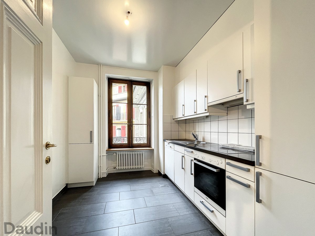 Schmale, helle Einbauküche mit Fenster