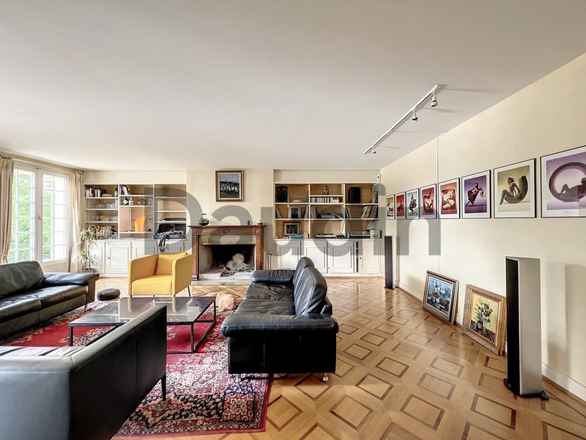 Wohnzimmer mit Kamin und Galerie-Wand