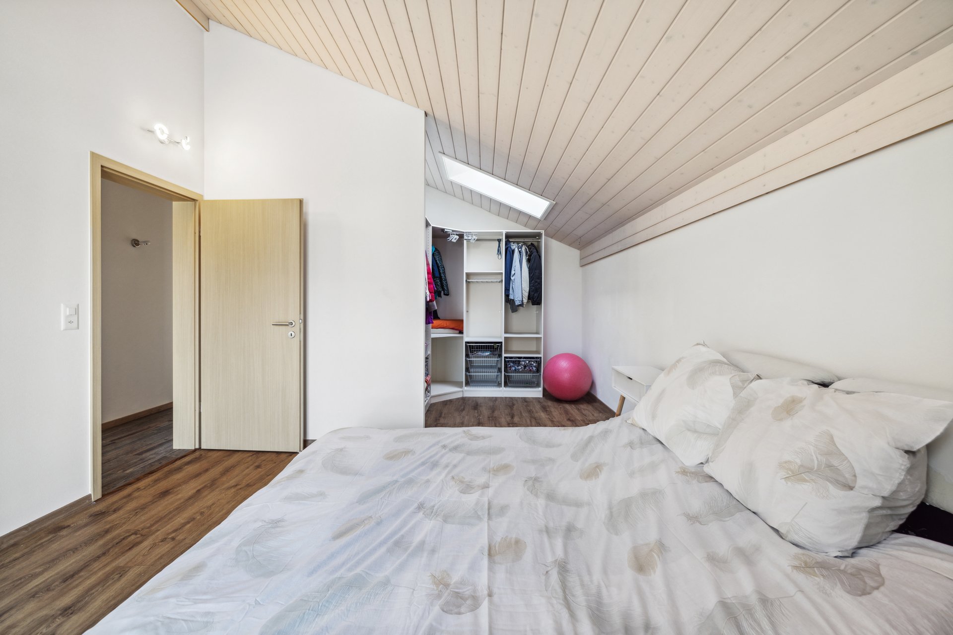 Helles Schlafzimmer mit Dachschräge und Ankleidebereich