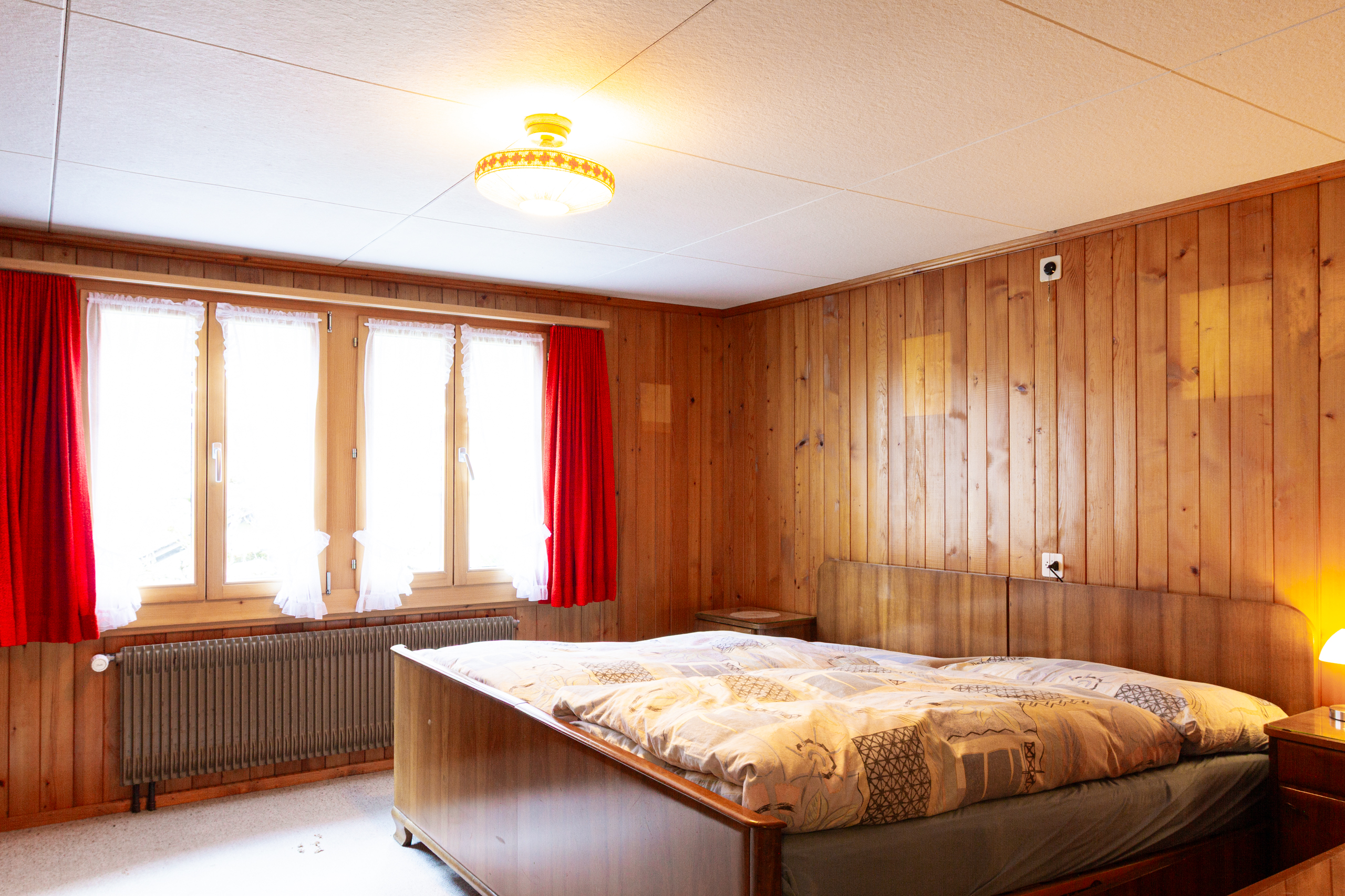 Rustikales Schlafzimmer mit Holzverkleidung
