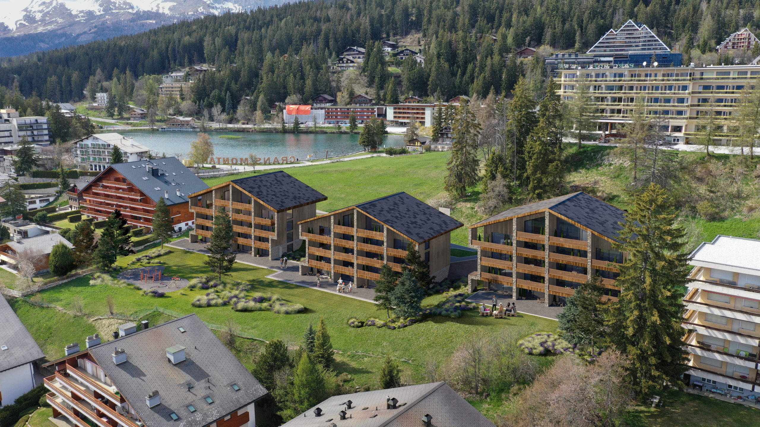 Luftaufnahme eines alpinen Ferien- und Wohnareals am See