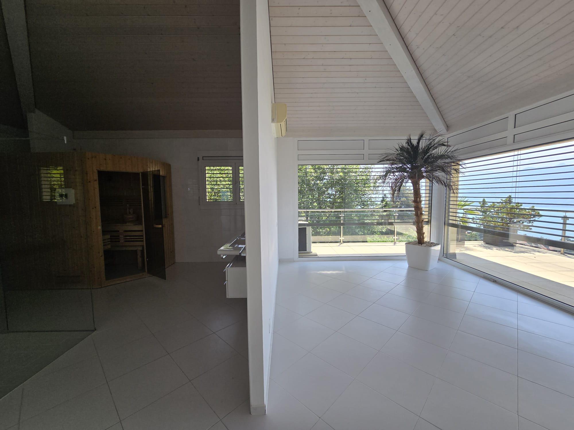 Heller Innenraum mit großer Glasfront und Sauna-Nische