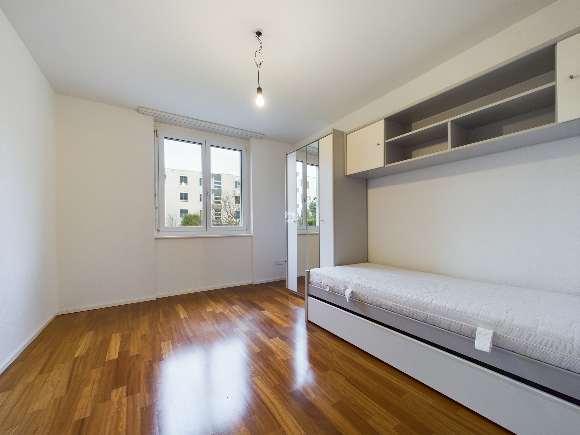 Helles Schlafzimmer mit Einbaubett und Fenster