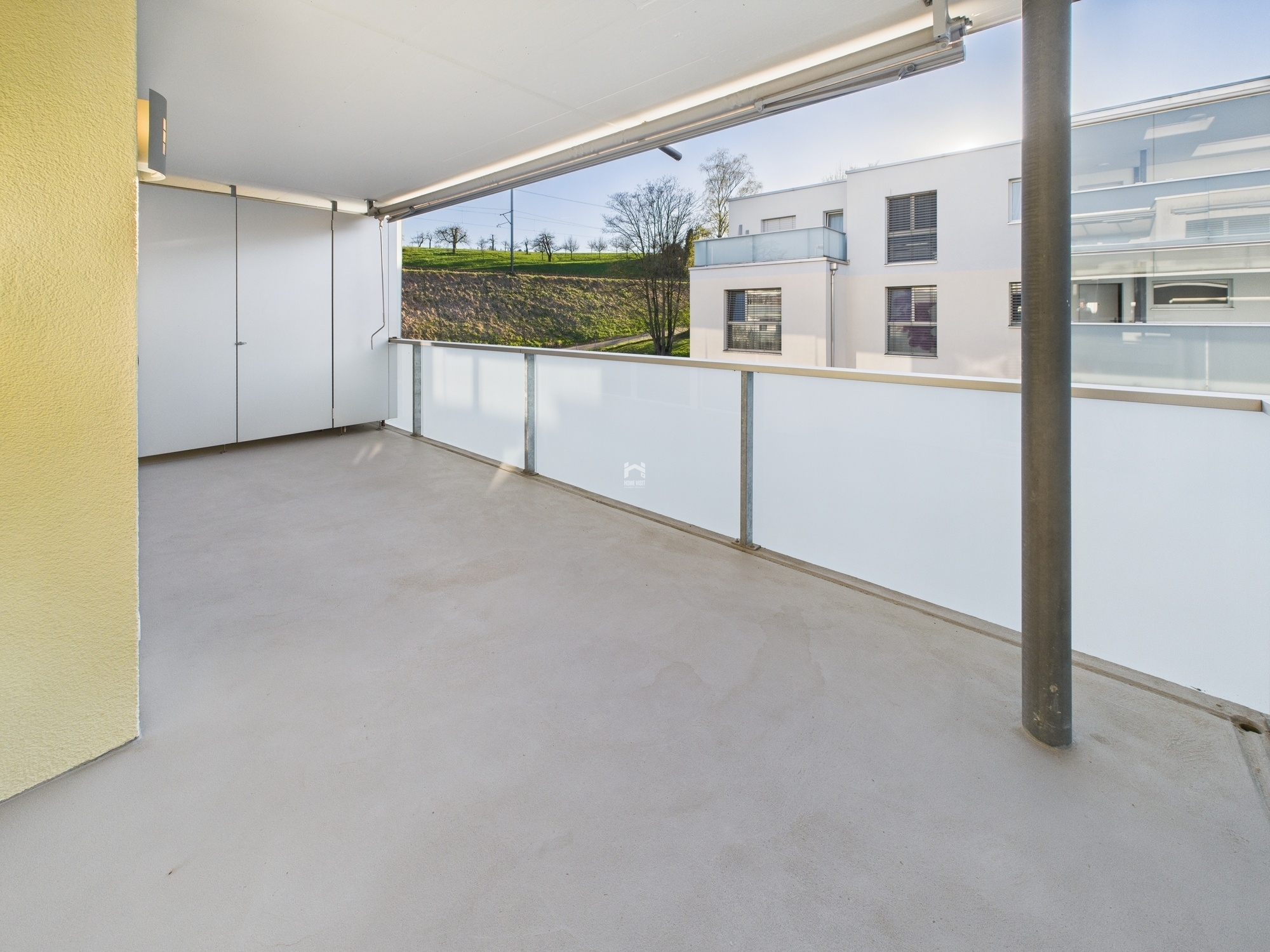 Überdachter Balkon mit Blick ins Grüne