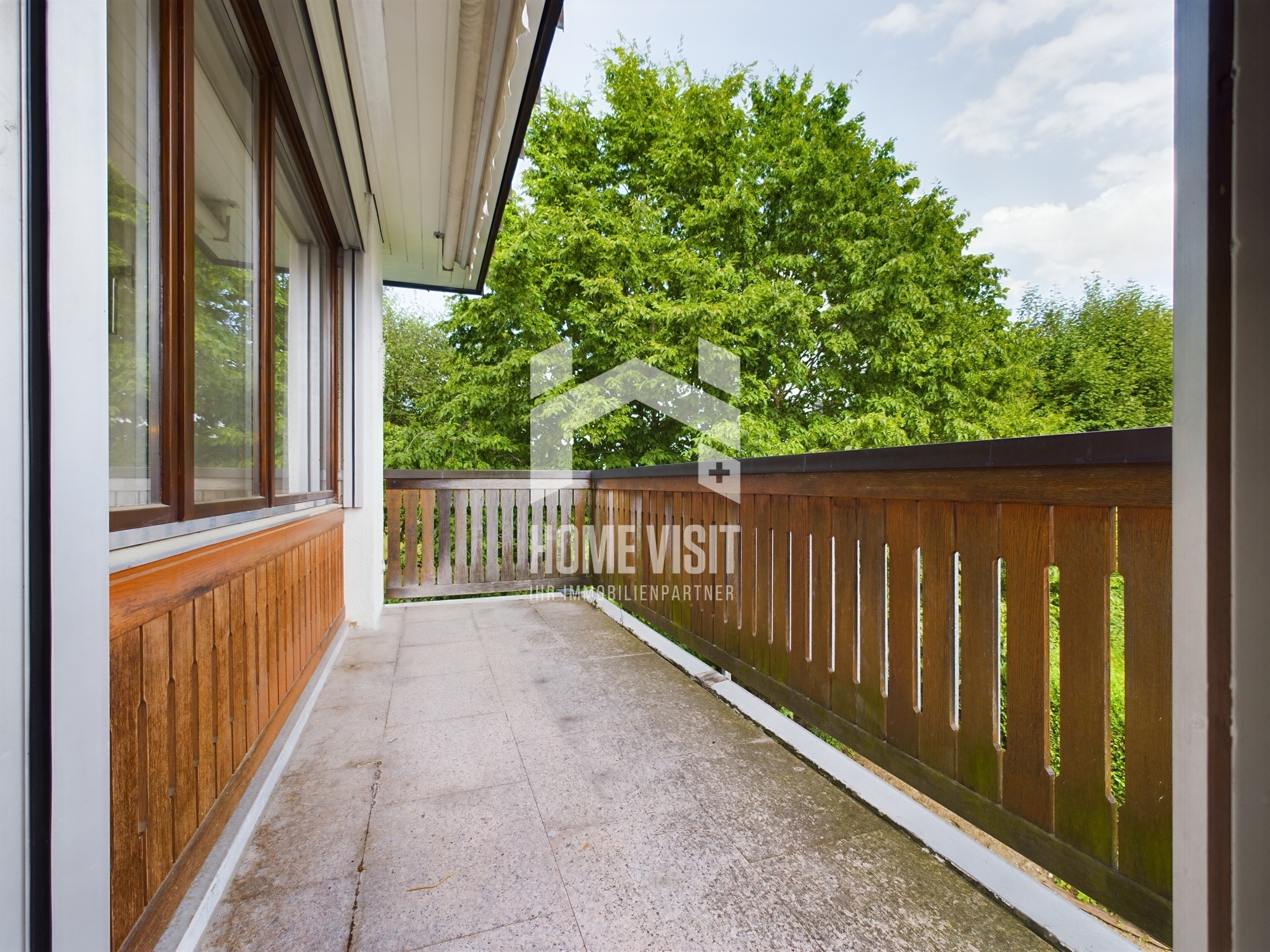Balkon mit Holzbrüstung und Blick ins Grüne