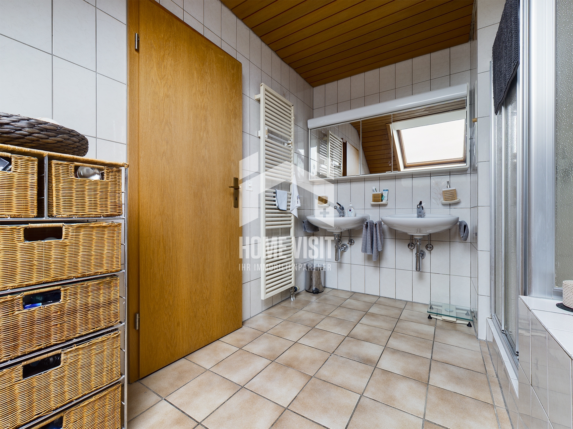 Badezimmer mit Doppelwaschbecken und Dachfenster