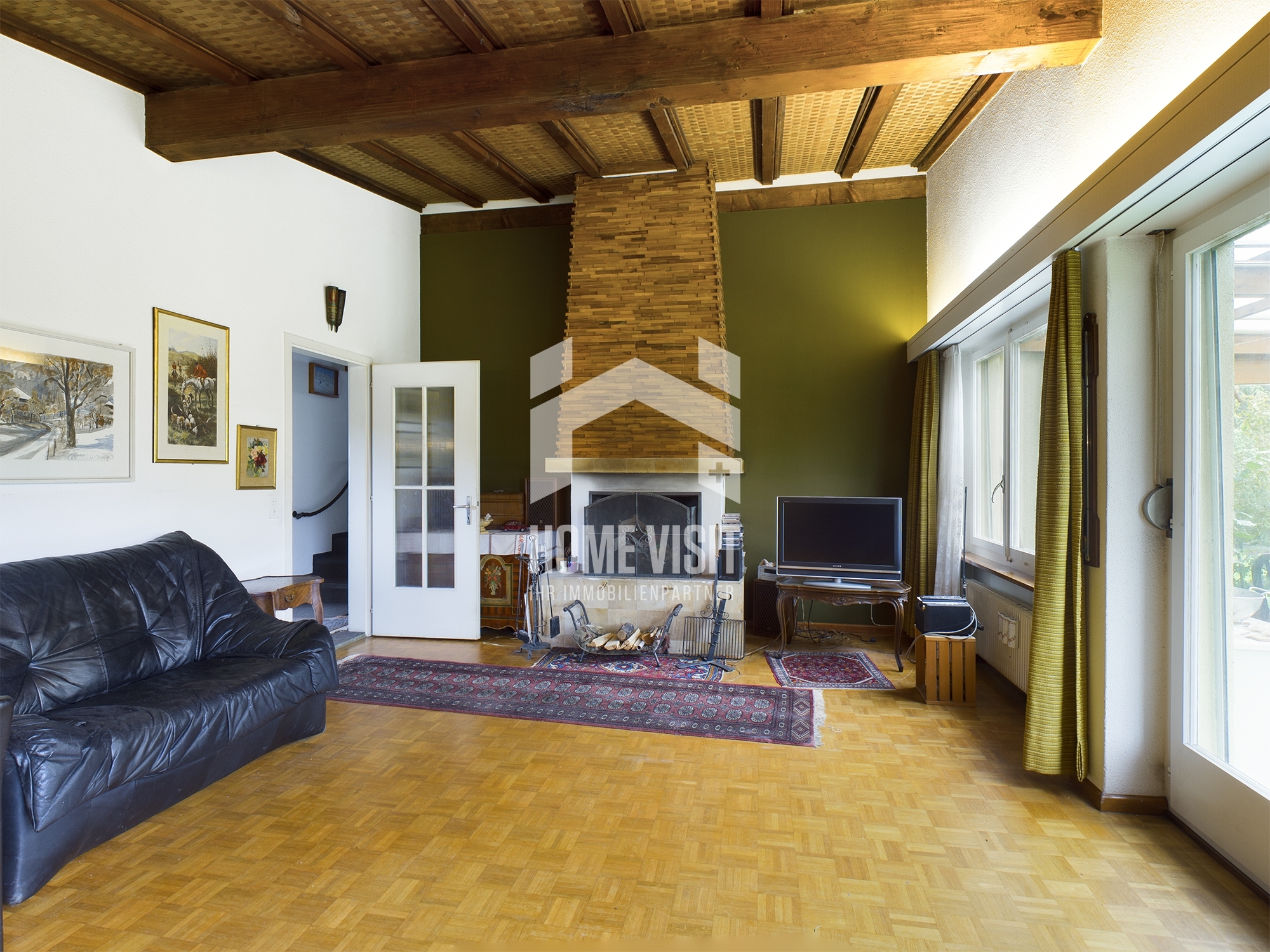 Wohnzimmer mit Kamin und Parkettboden
