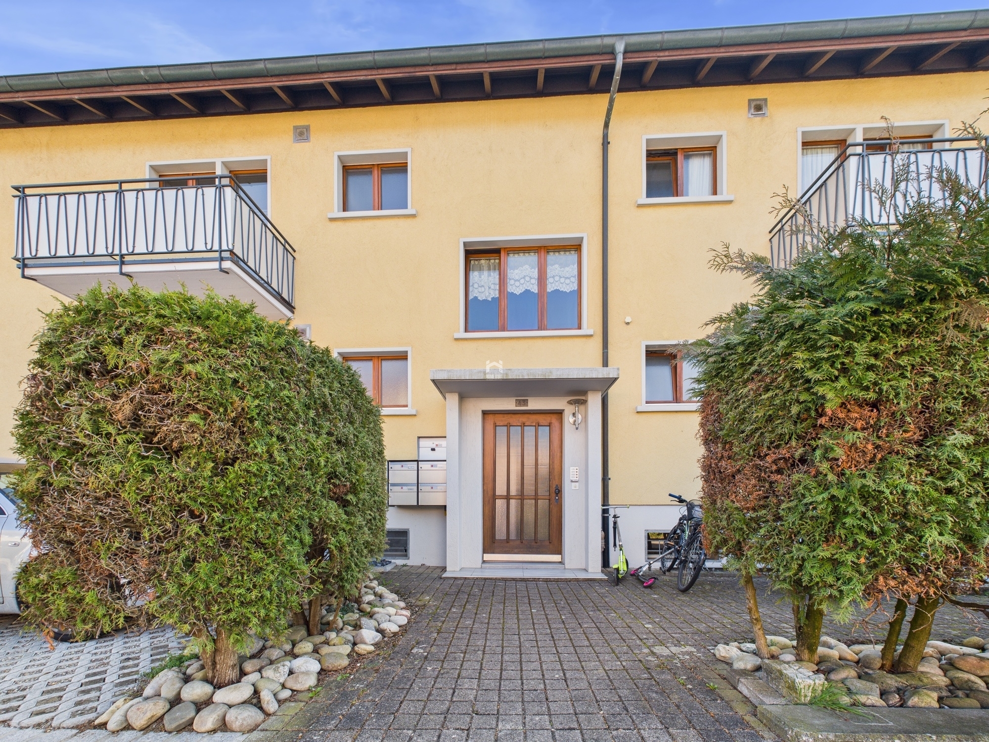 Mehrfamilienhaus mit Eingangsbereich und Balkonen