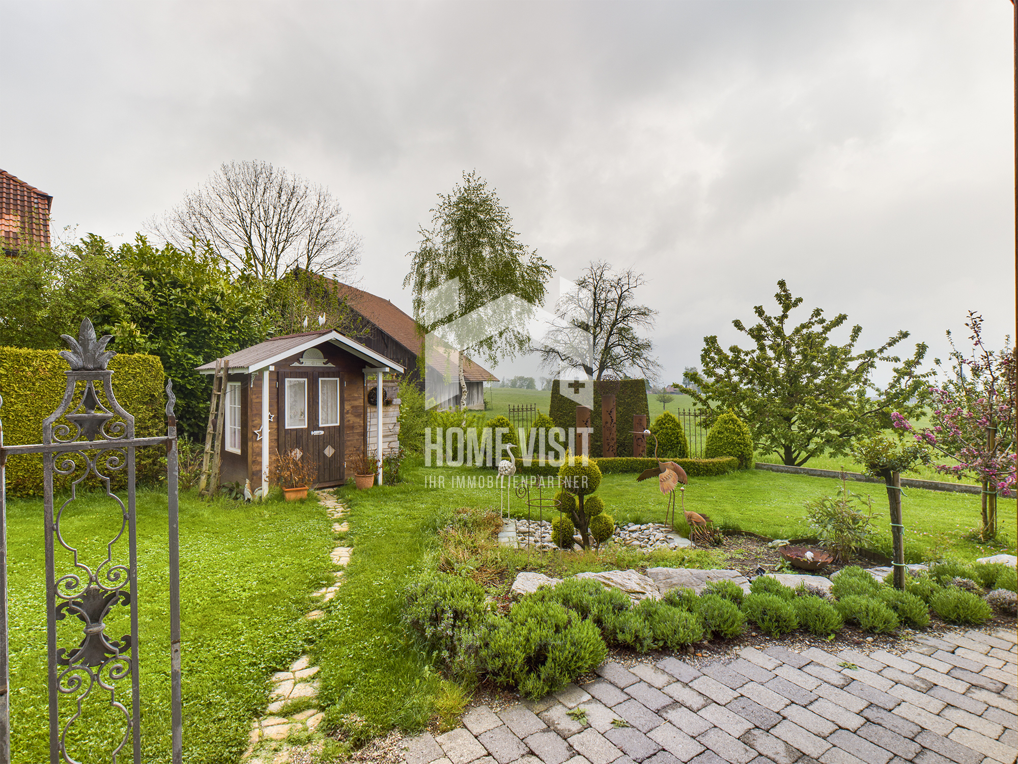 Gepflegter Garten mit kleinem Holzpavillon