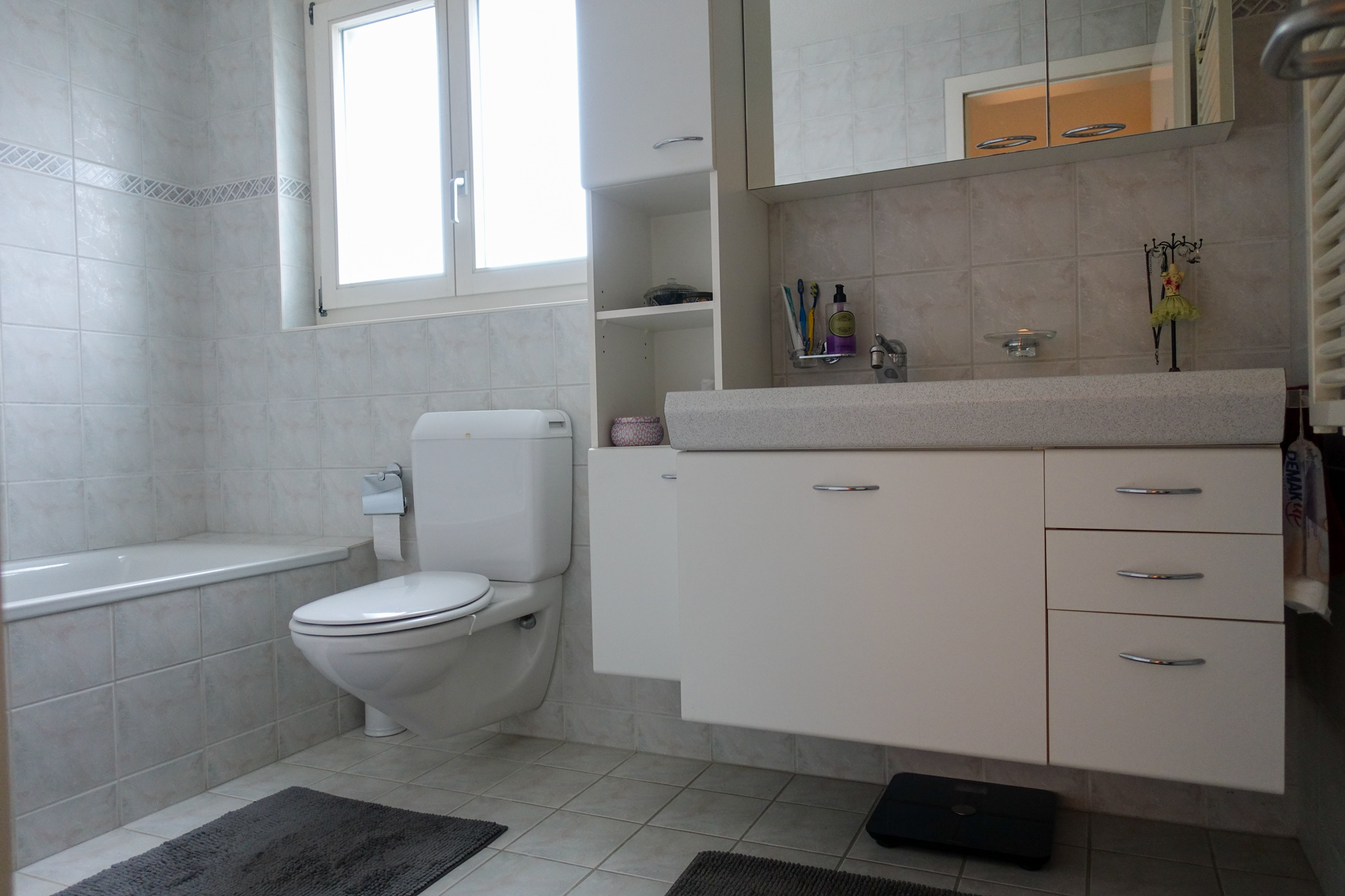 Helles Badezimmer mit Badewanne, WC und Waschtisch