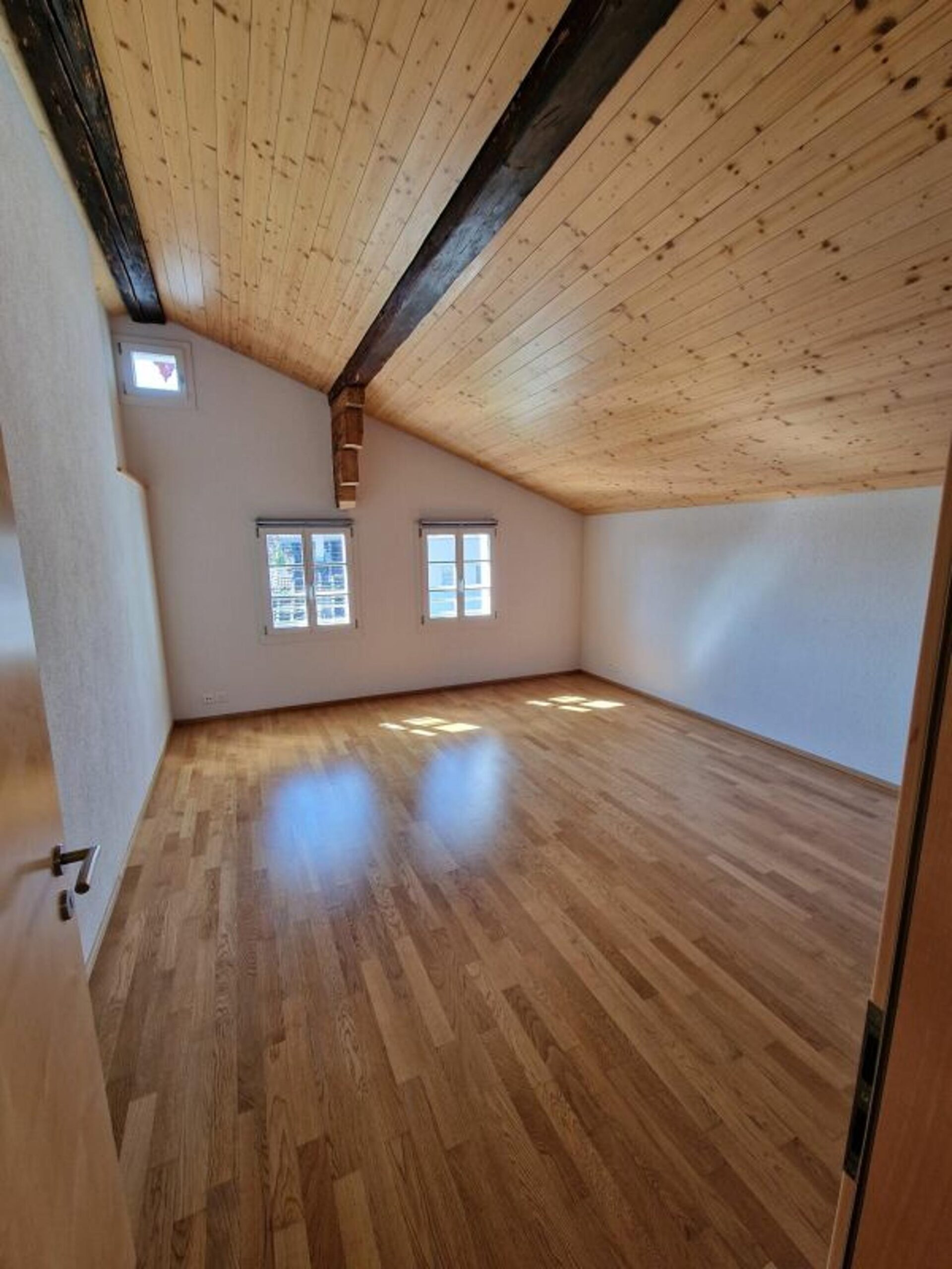 Leeres Dachzimmer mit Holzbalkendecke
