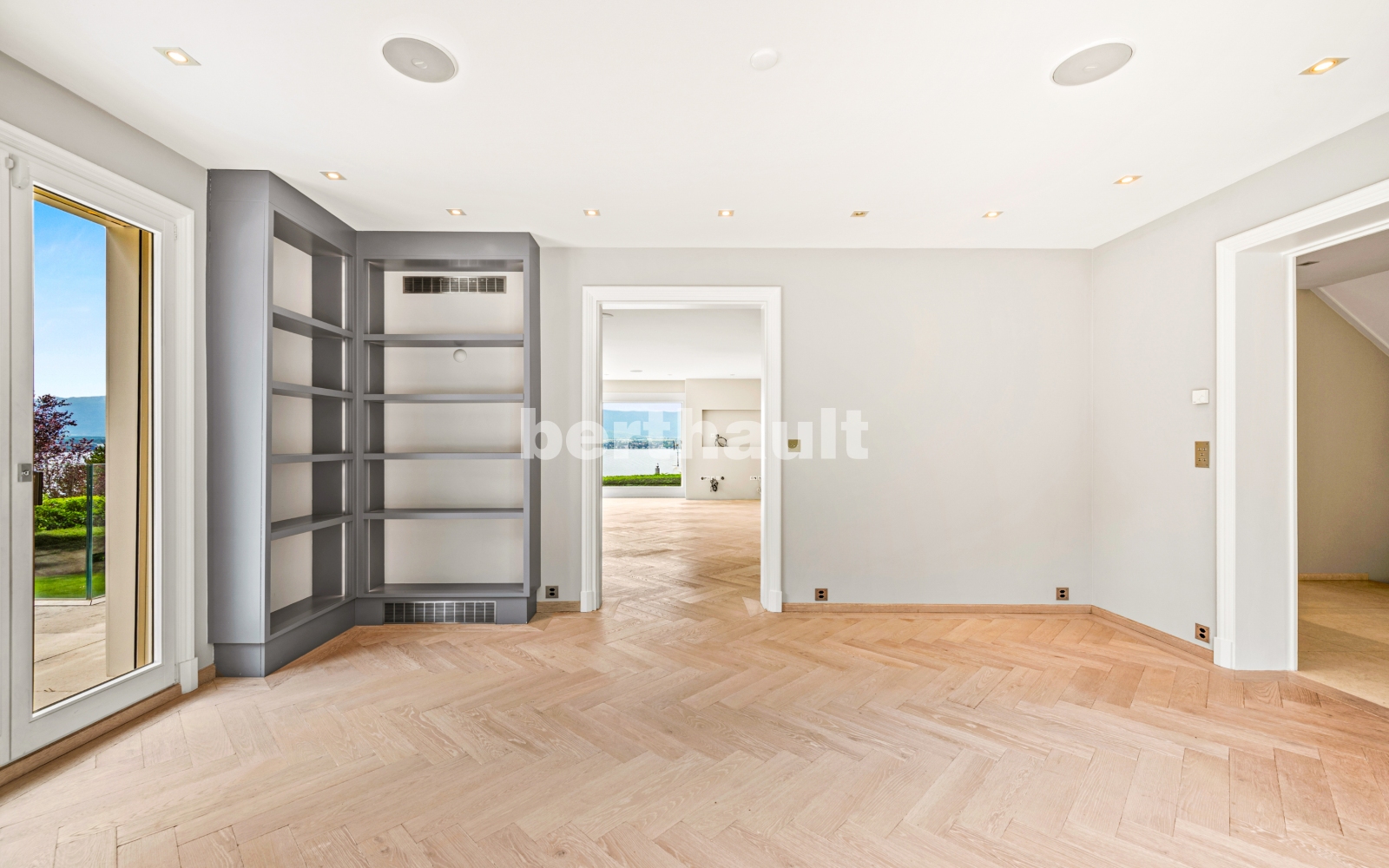 Helles leeres Zimmer mit Fischgrätparkett und Meerblick