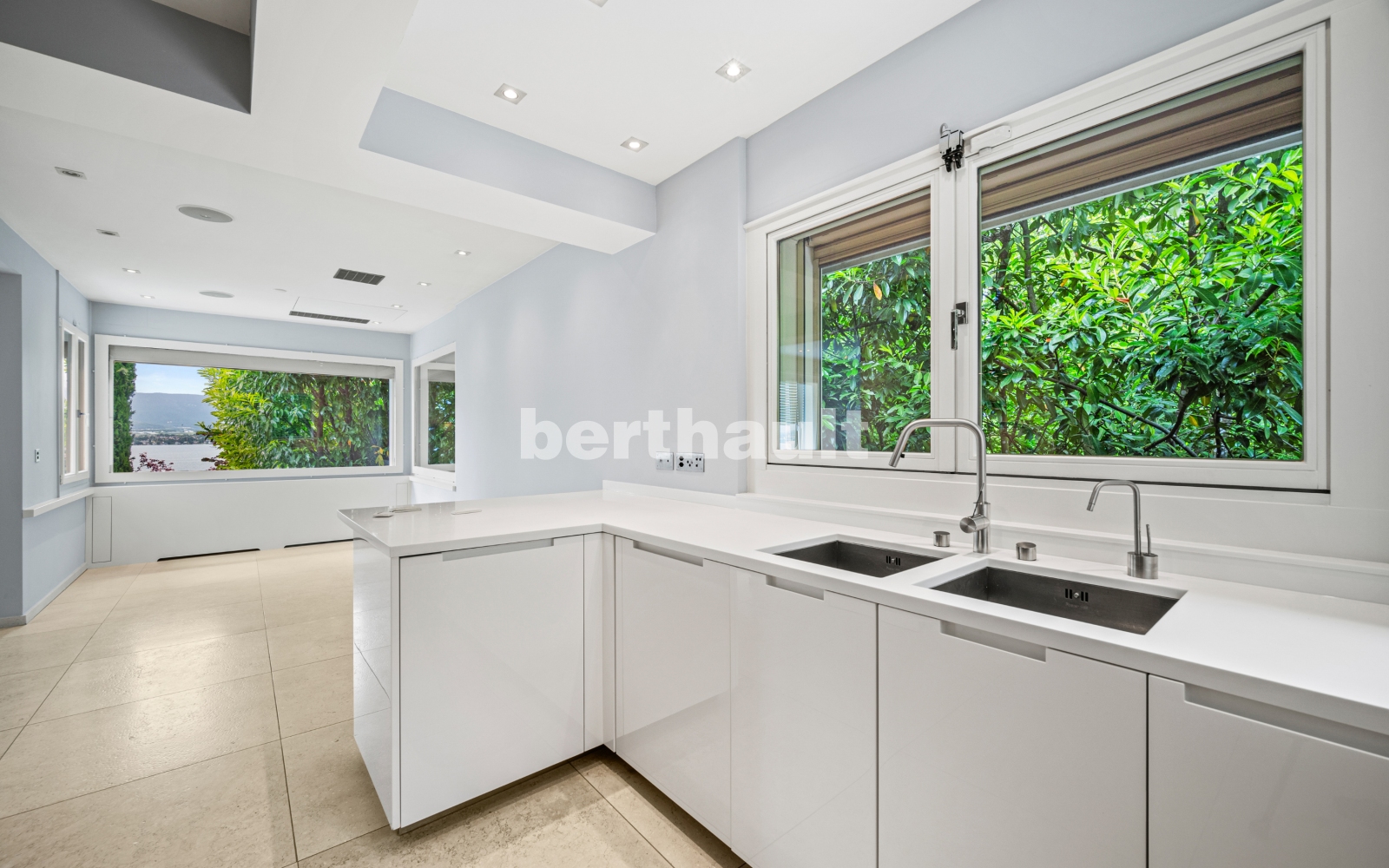 Helle moderne Küche mit großem Fenster und Blick ins Grüne