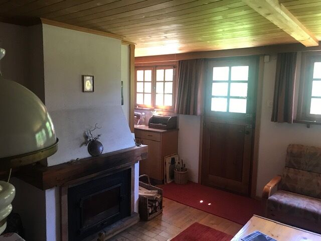 Gemütliches Wohnzimmer mit Kamin und Holzbalkendecke