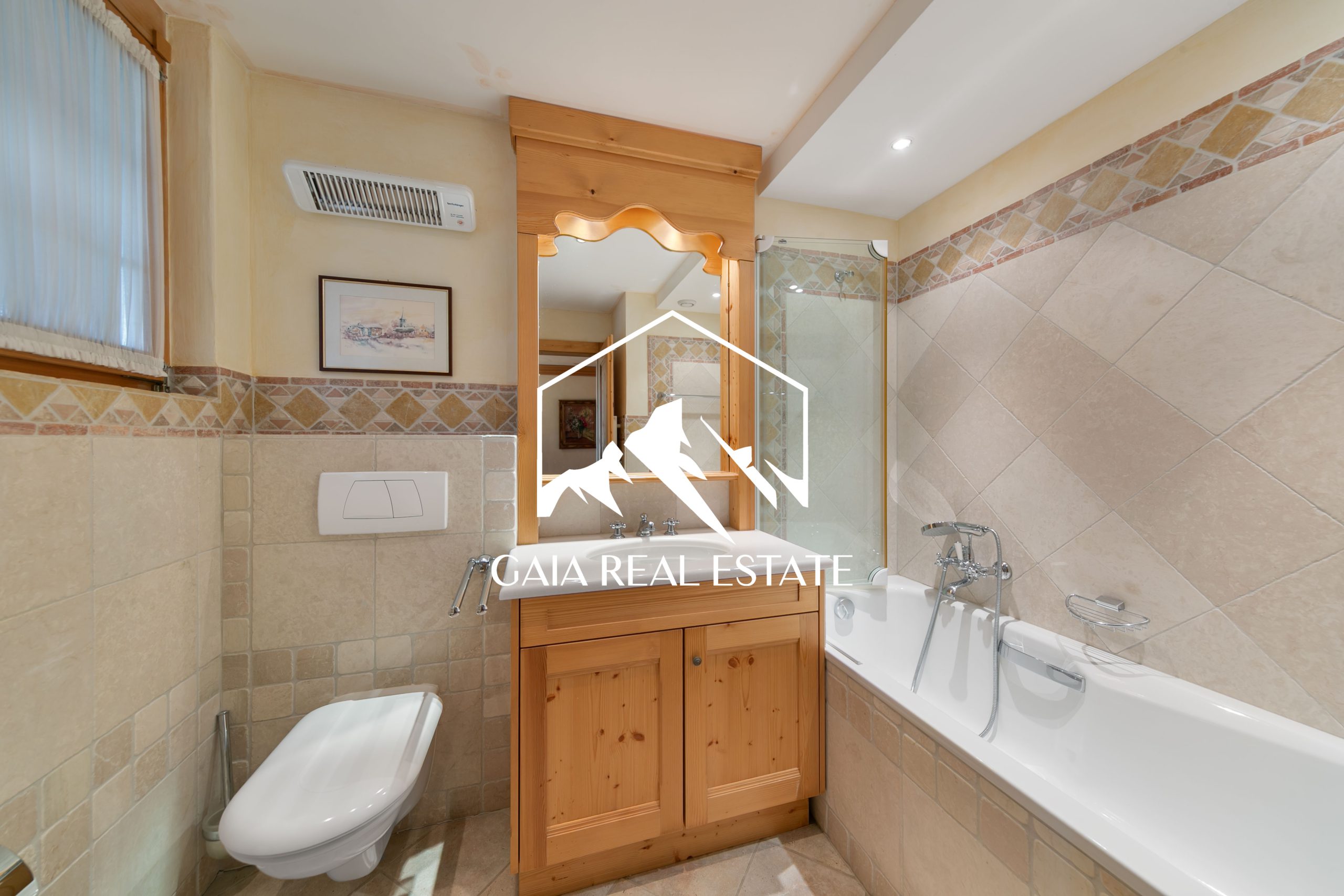 Badezimmer mit Badewanne und Holzwaschtisch