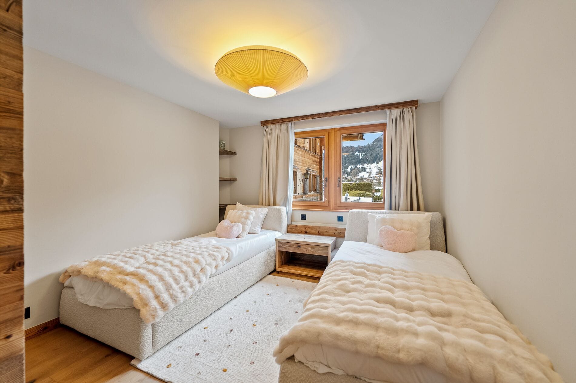 Helles Schlafzimmer mit zwei Einzelbetten und Bergblick