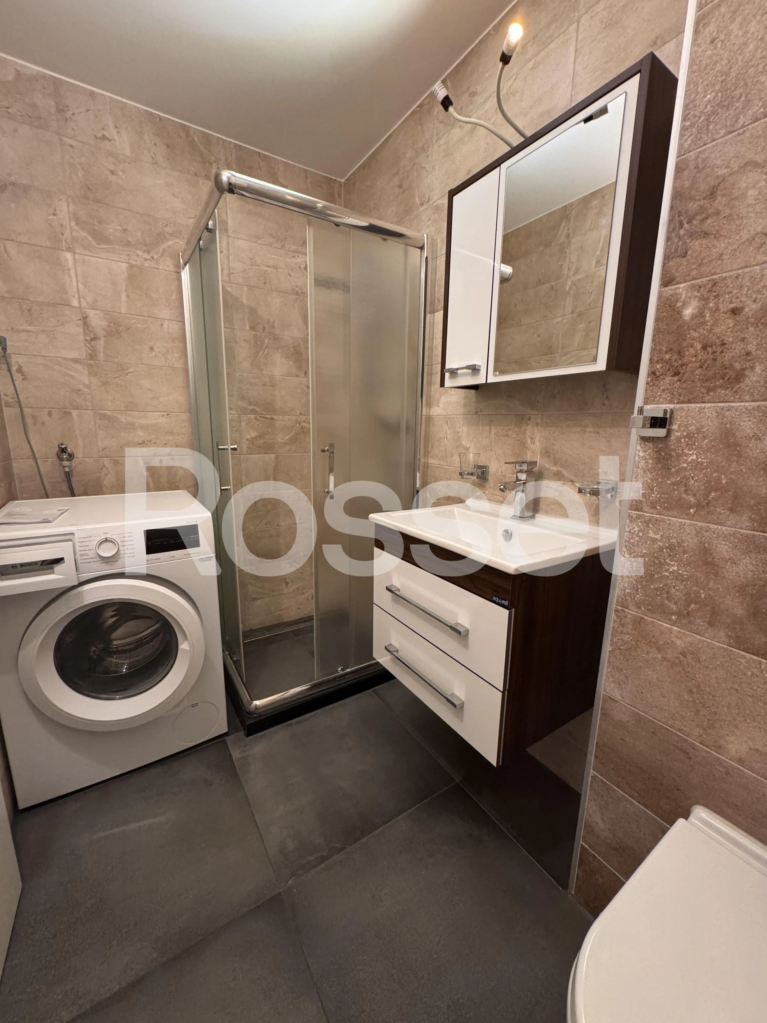 Modernes Badezimmer mit Dusche, Waschtisch und Waschmaschine