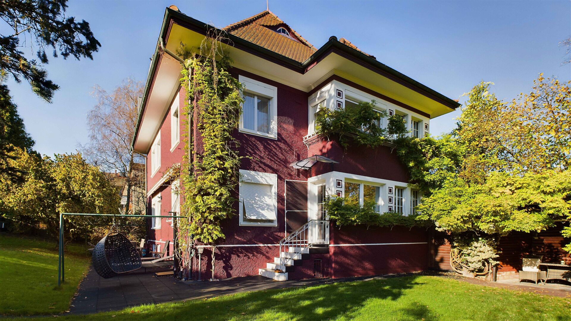 Außenansicht eines villenartigen Wohnhauses mit Garten