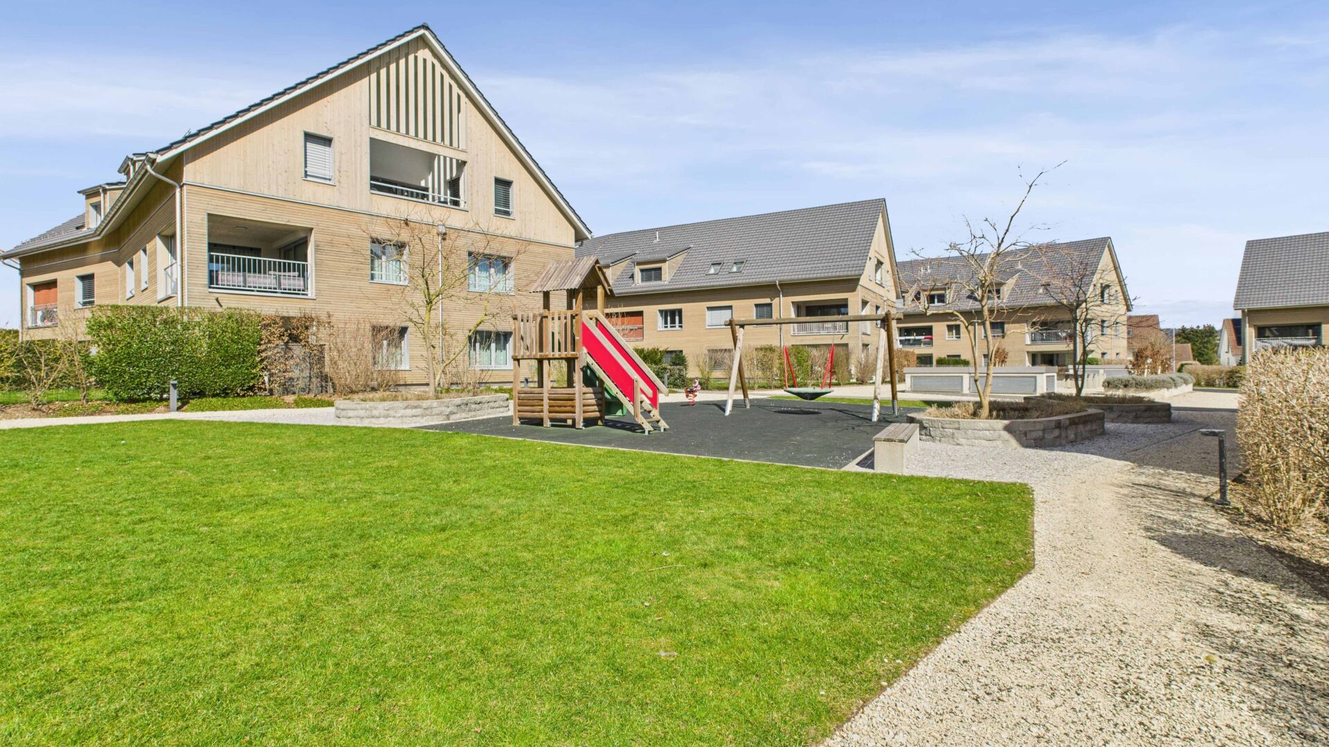 Außenansicht einer Wohnanlage mit Spielplatz