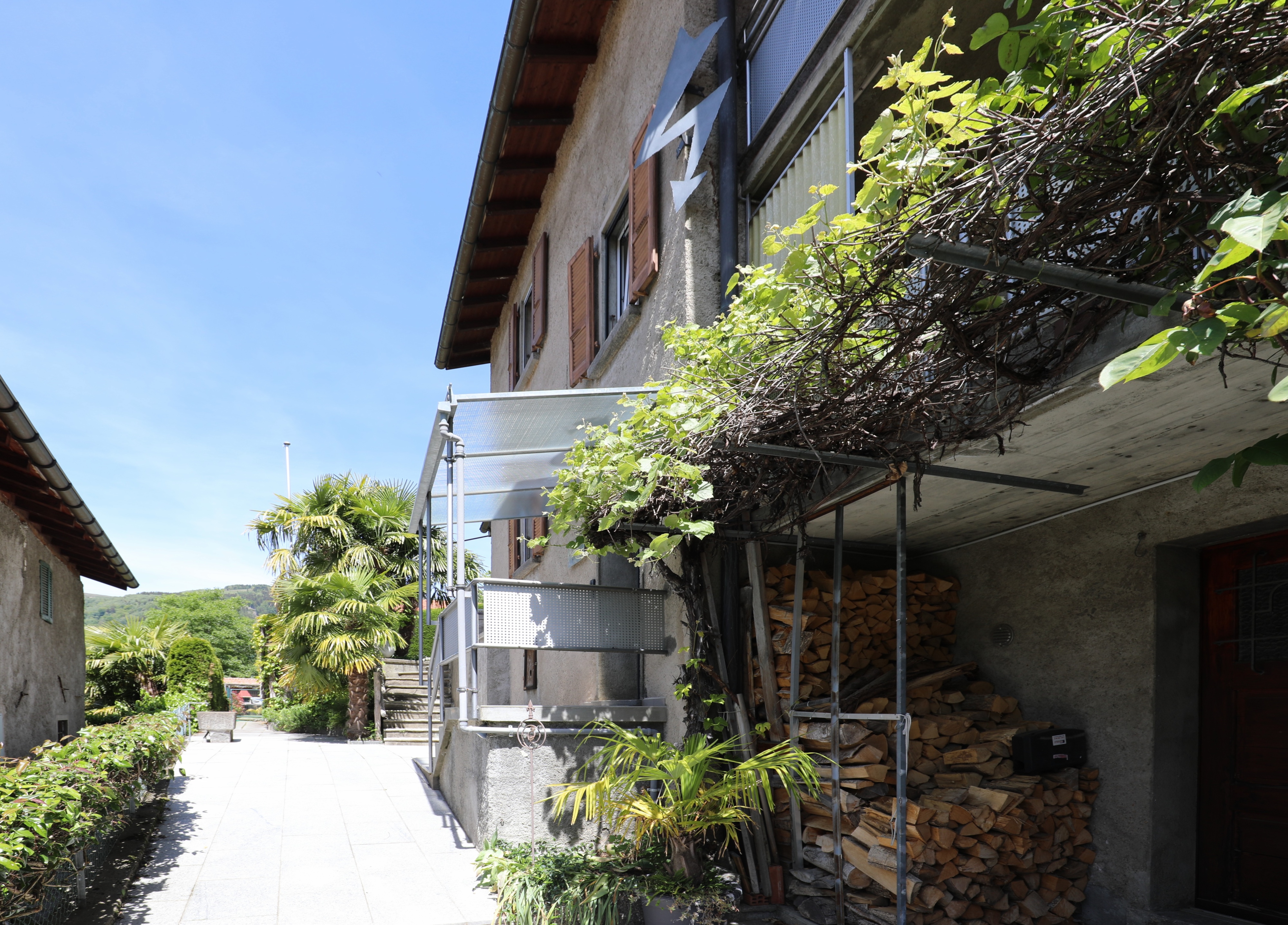Außenansicht eines Wohngebäudes mit Balkon und Begrünung