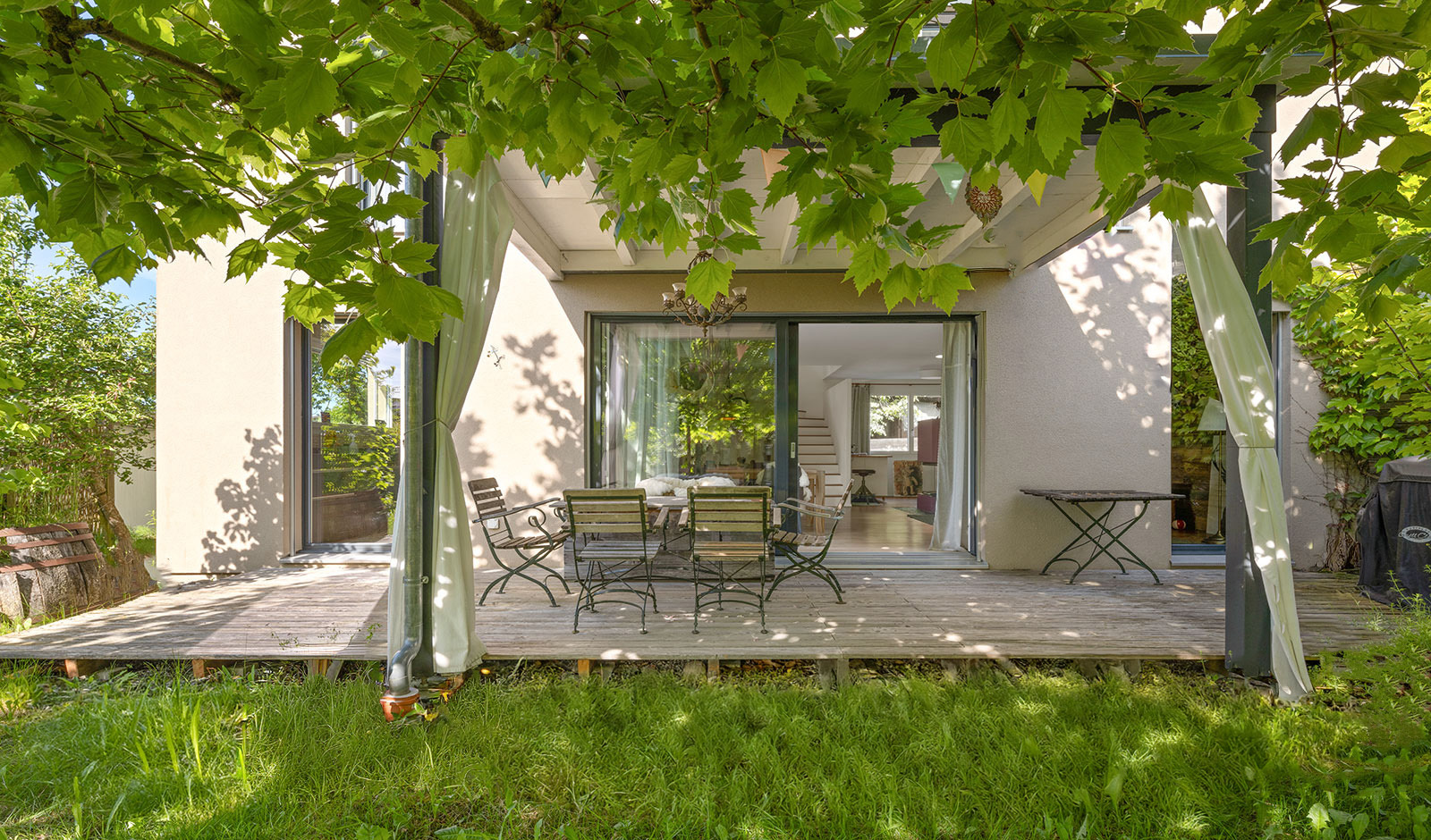 Überdachte Terrasse mit Gartenblick
