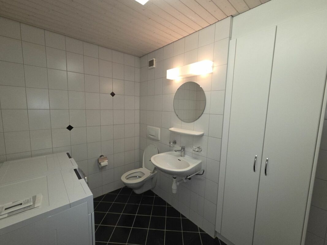 Gäste-WC mit Waschbecken und Schrank