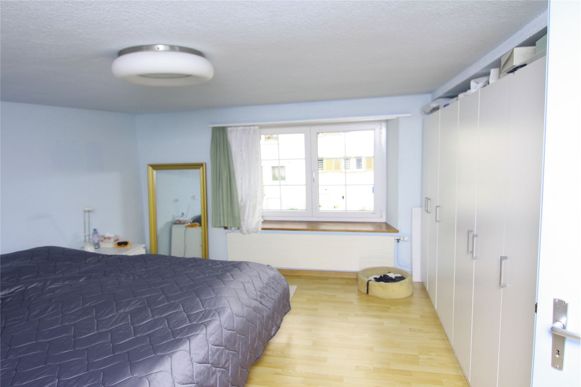 Schlafzimmer mit großem Kleiderschrank und Fenster