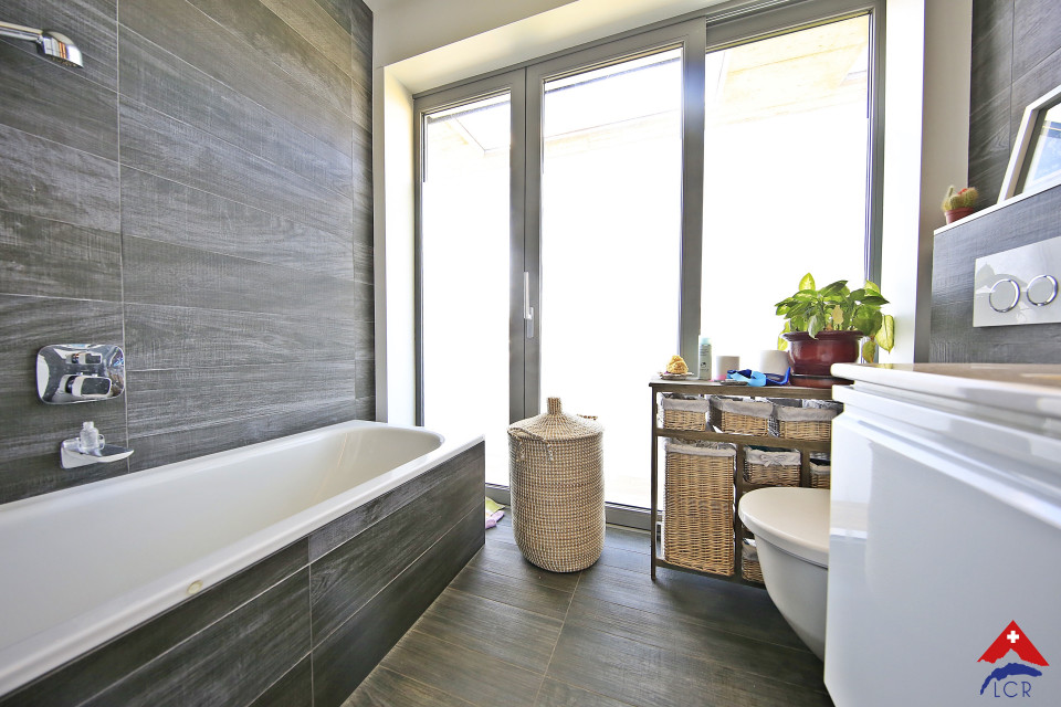 Modernes Badezimmer mit Badewanne und bodentiefem Fenster