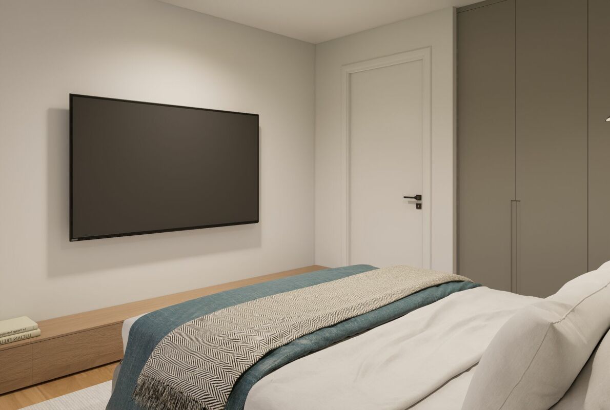 Schlafzimmer mit Wand-TV und Einbauschrank
