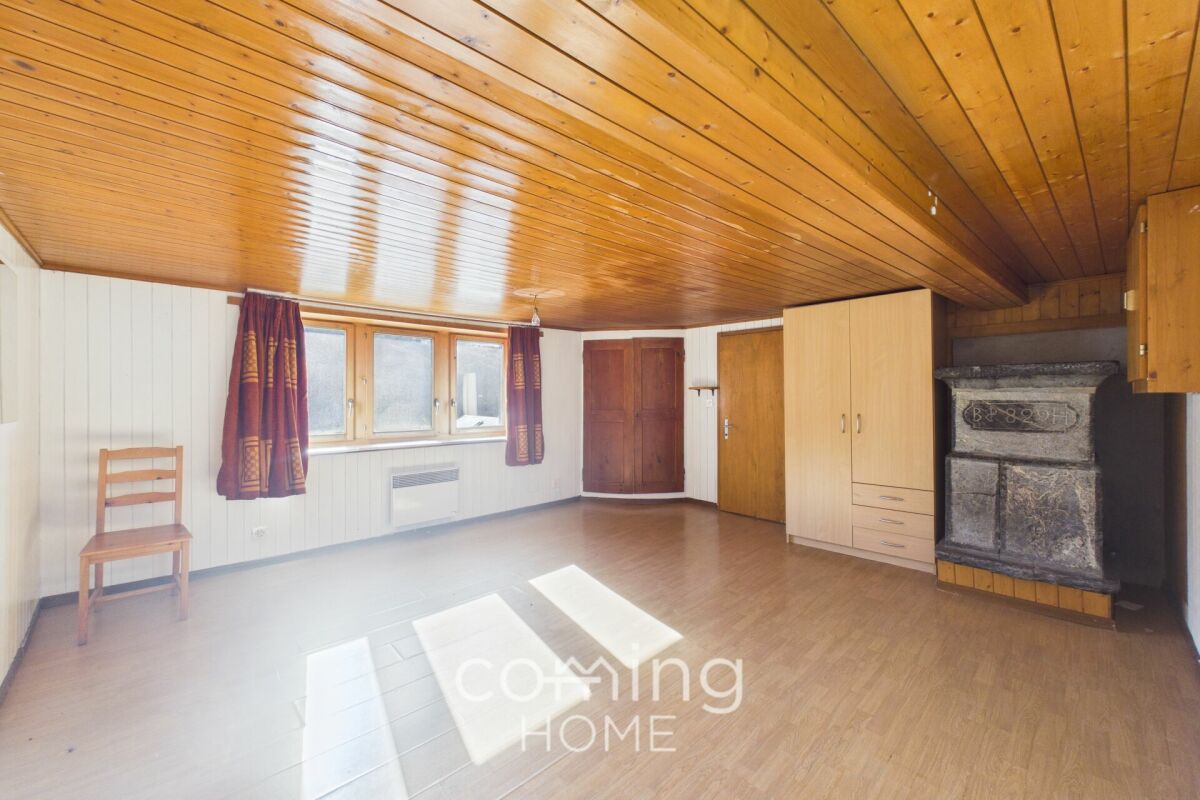 Rustikaler Wohnraum mit Holzdecke und Ofen