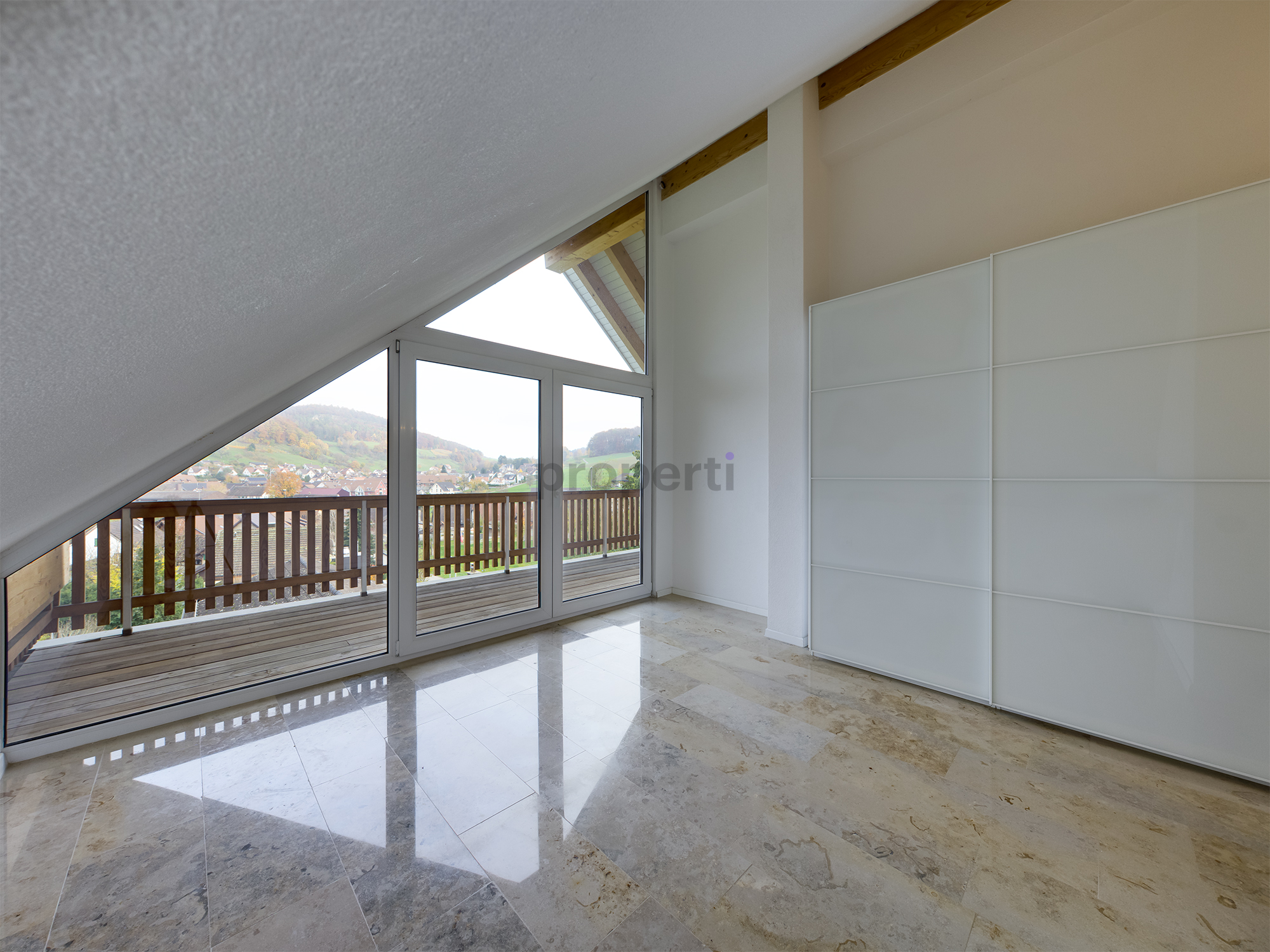 Helles Dachgeschosszimmer mit Balkon und Ausblick