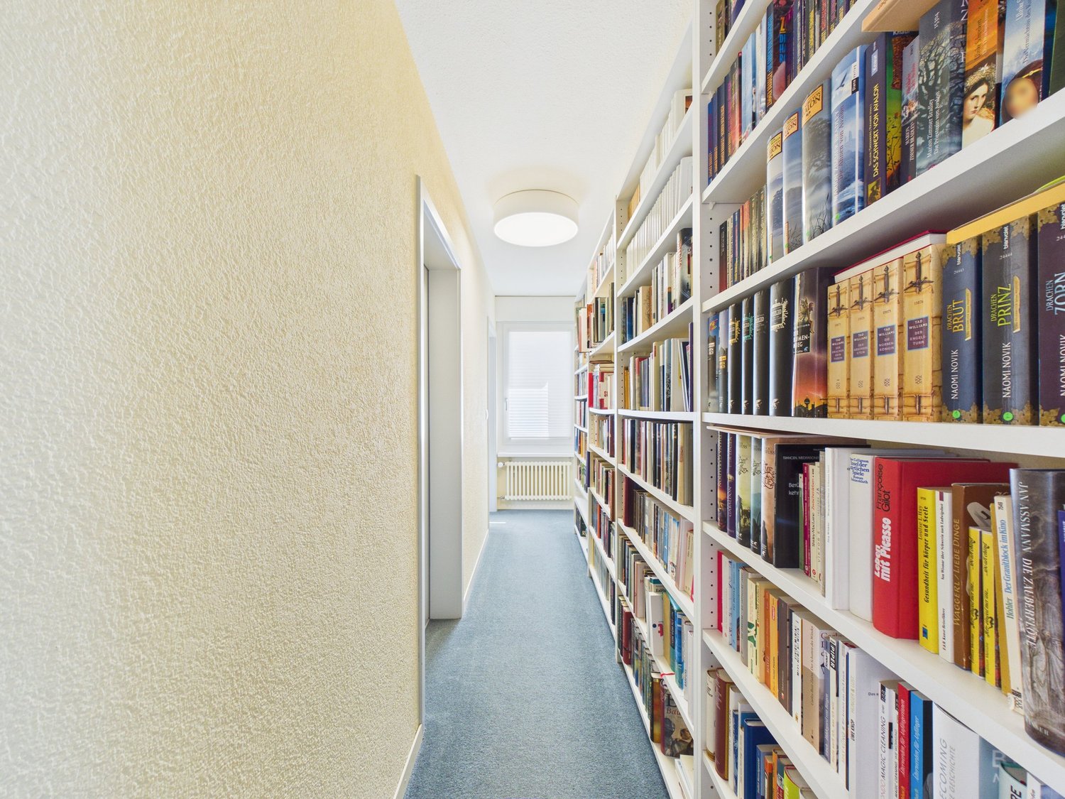 Heller Flur mit Bücherregalen