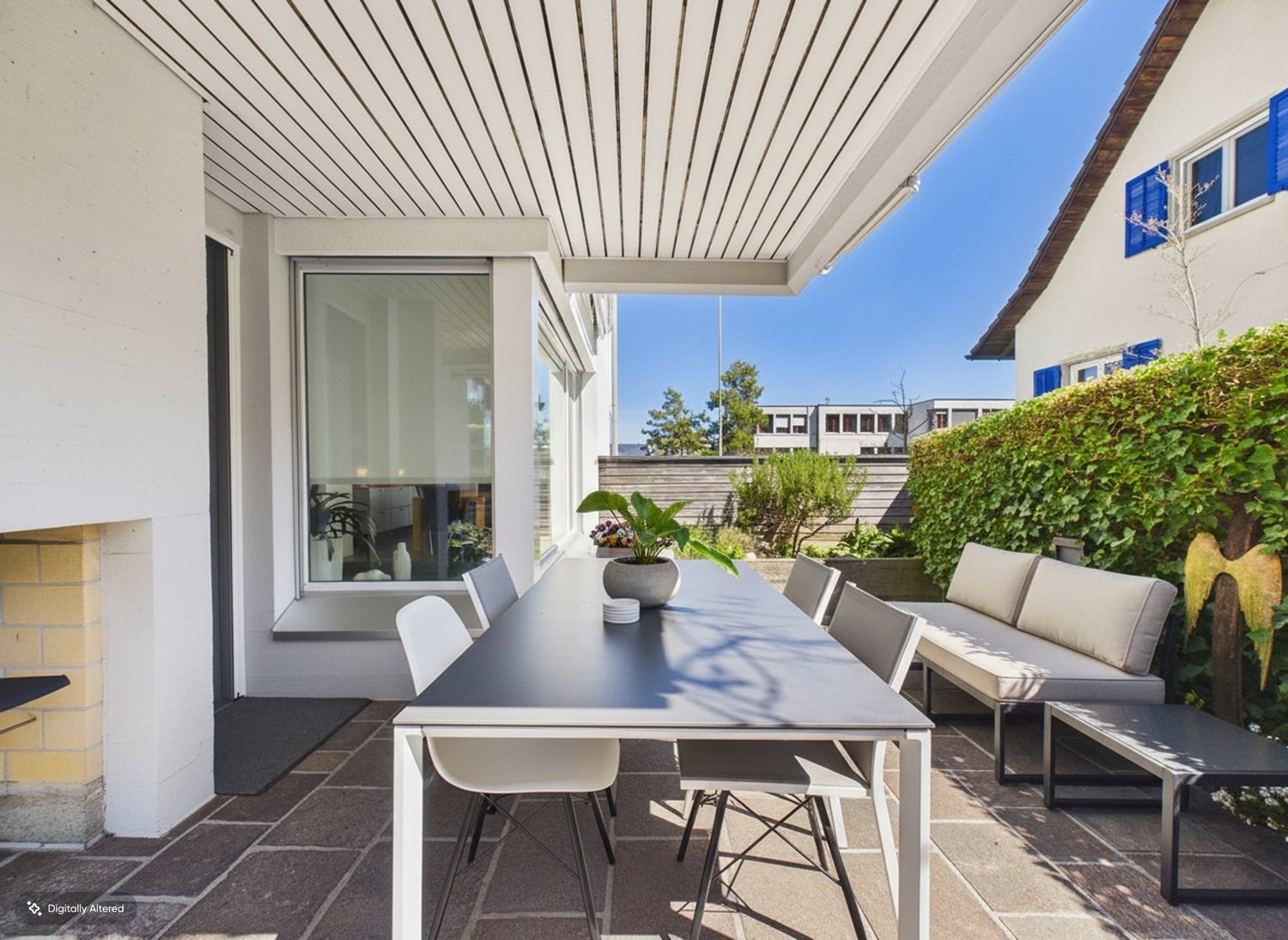 Überdachte Terrasse mit Esstisch und Lounge