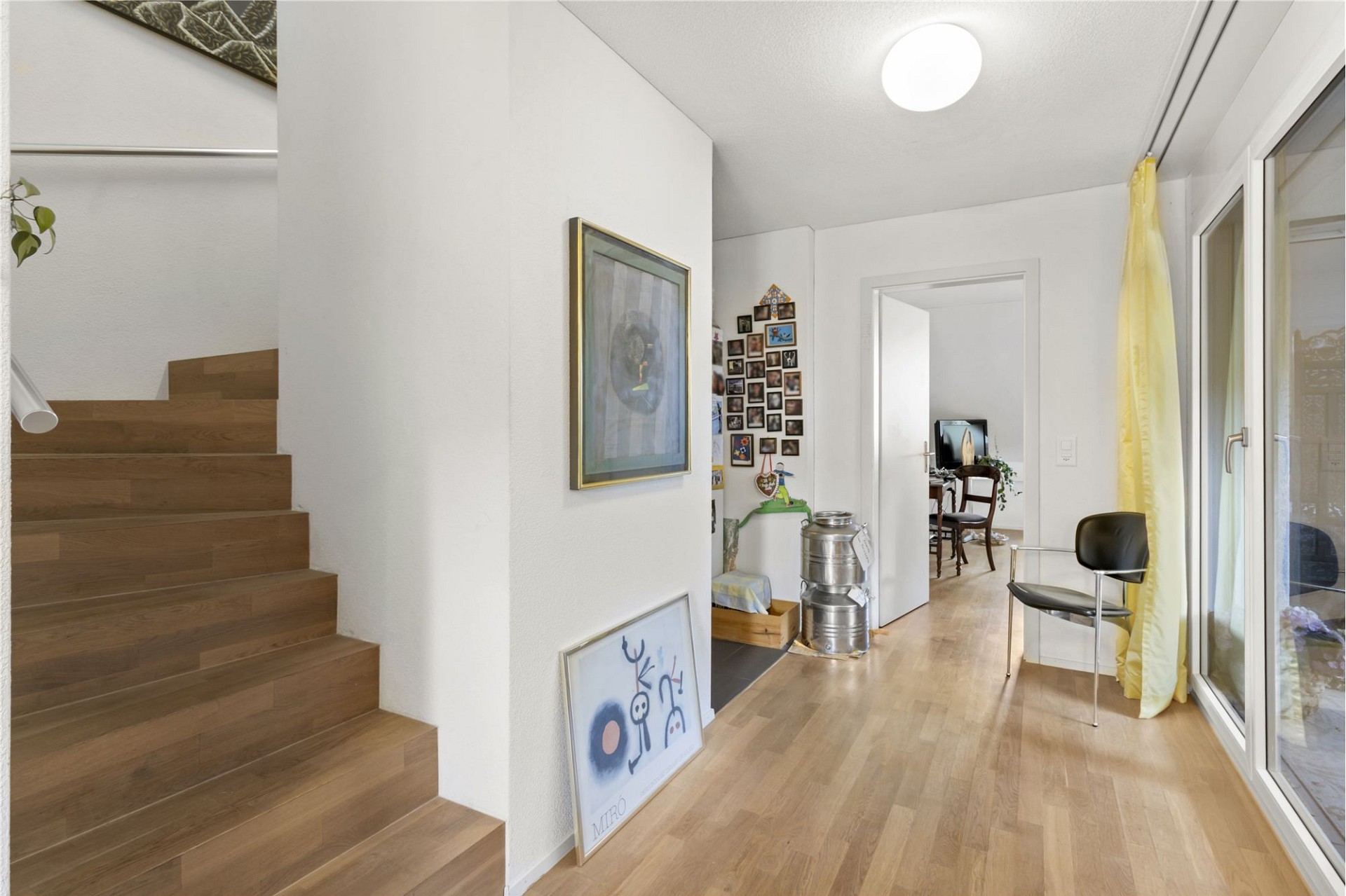 Heller Flur mit Treppe und Balkonzugang