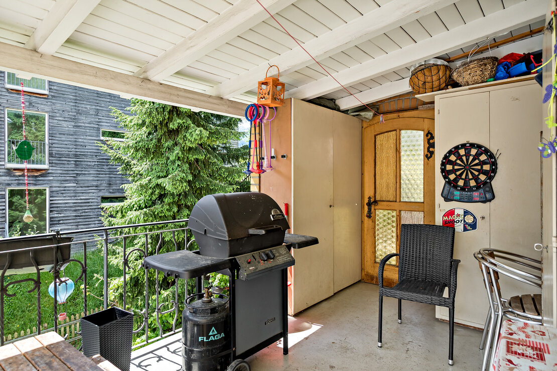 Überdachter Balkon mit Grill und Dartscheibe