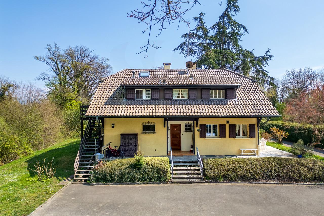 Hausansicht mit Walmdach und Garten