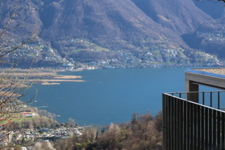 Seeblick mit Bergkulisse und moderner Balkonbrüstung