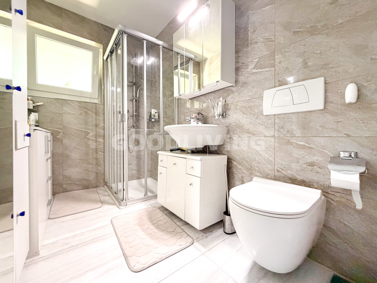 Modernes Badezimmer mit Dusche, Waschtisch und wandhängendem WC