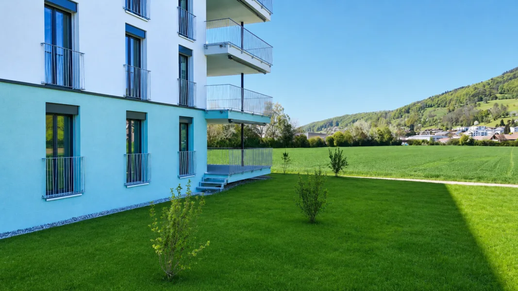 Mehrfamilienhaus mit Balkon und Gartenblick