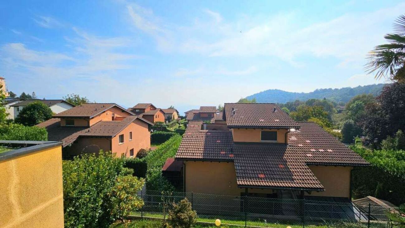 Wohnsiedlung mit Terrakotta-Dächern und Bergblick