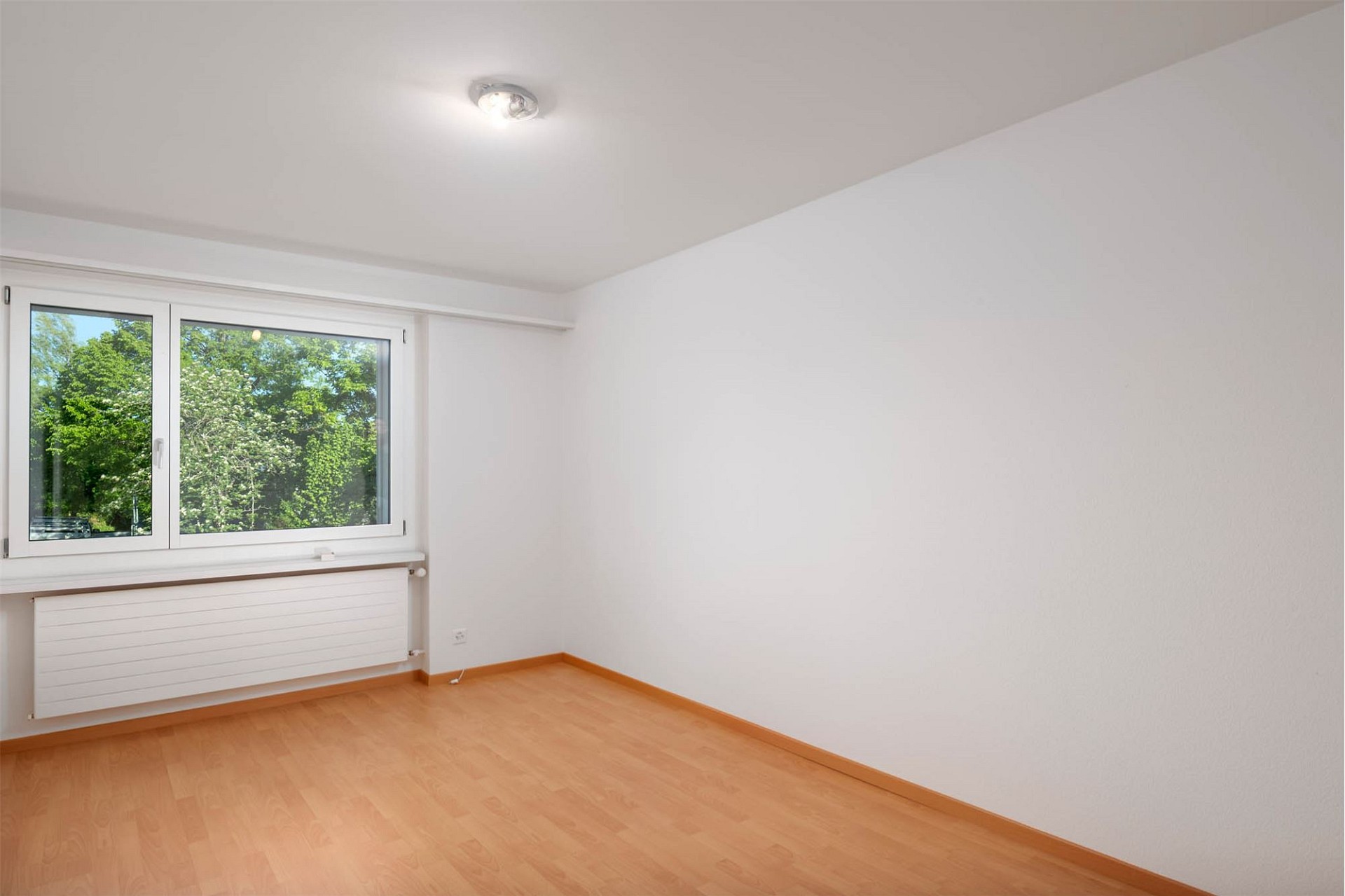 Heller leerer Raum mit Fenster und Heizkörper