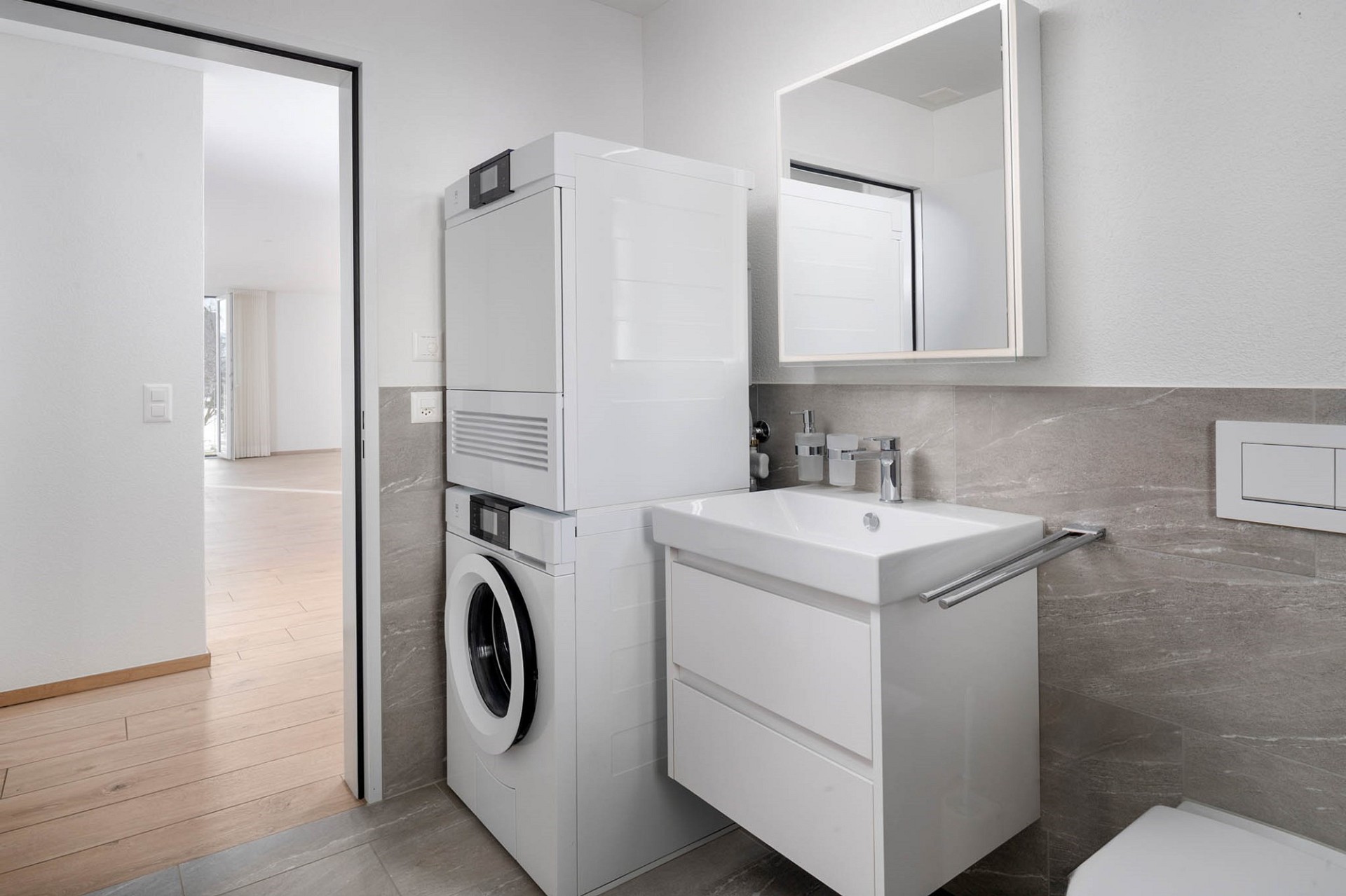 Moderne Waschküche mit Waschmaschine und Waschtisch