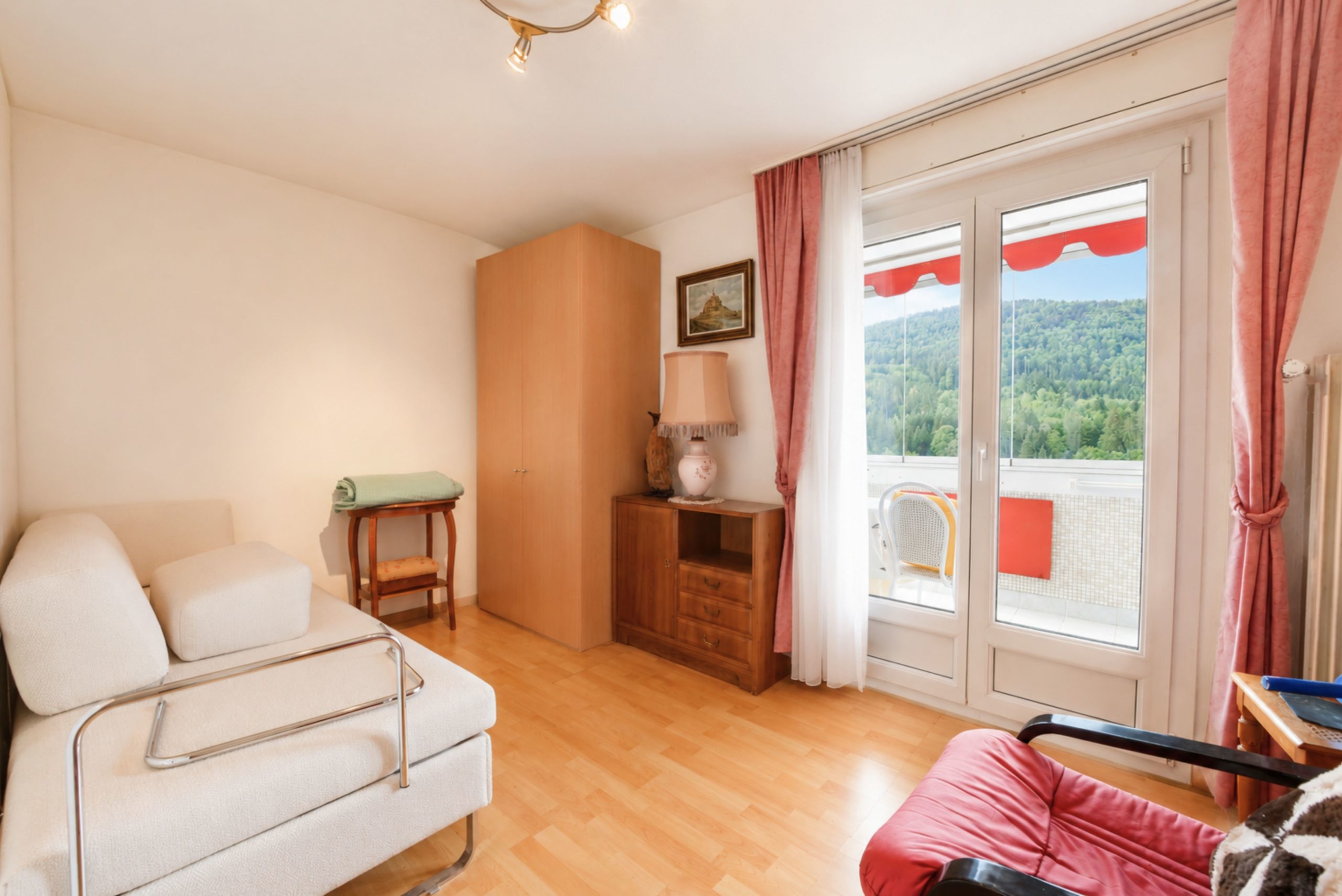 Helles Wohn- bzw. Schlafzimmer mit Balkonblick
