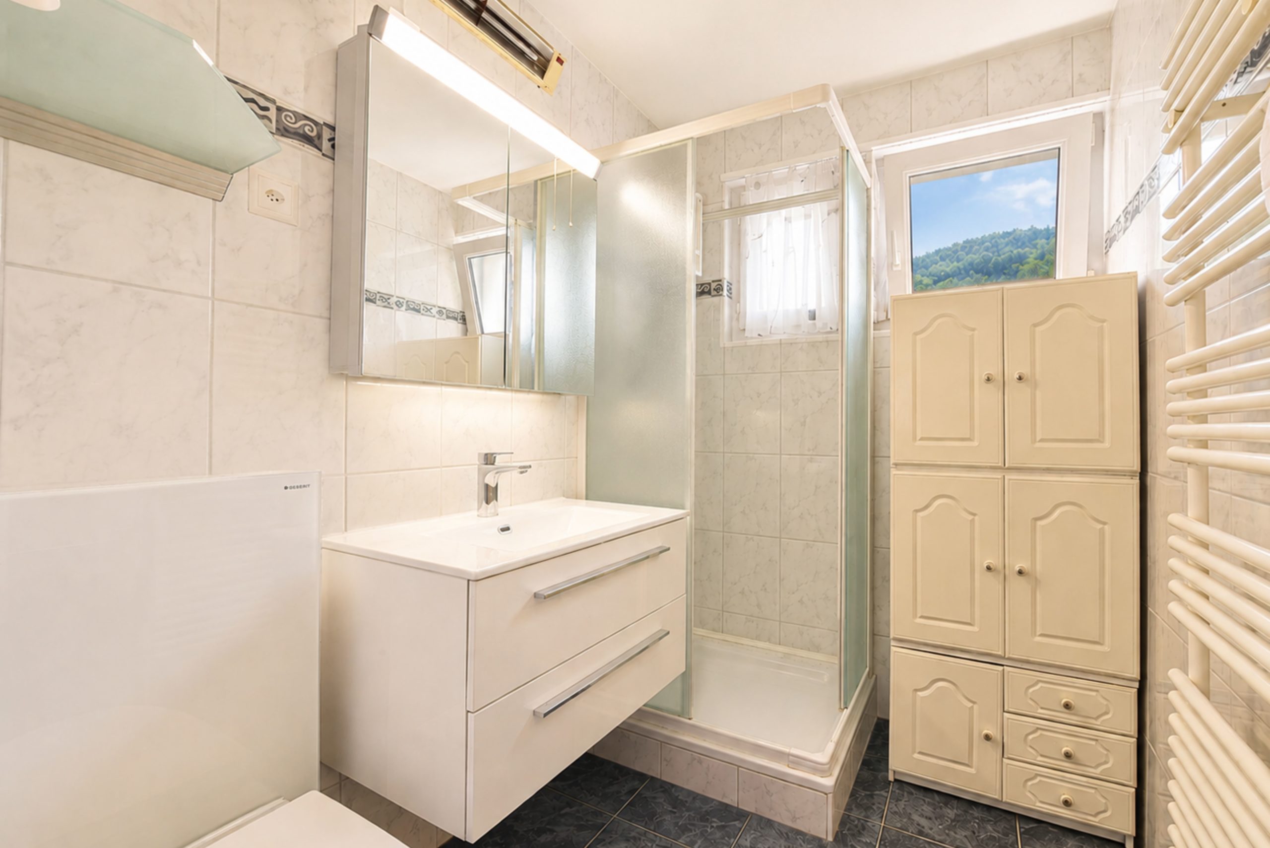 Helles Badezimmer mit Dusche und Einbauschränken