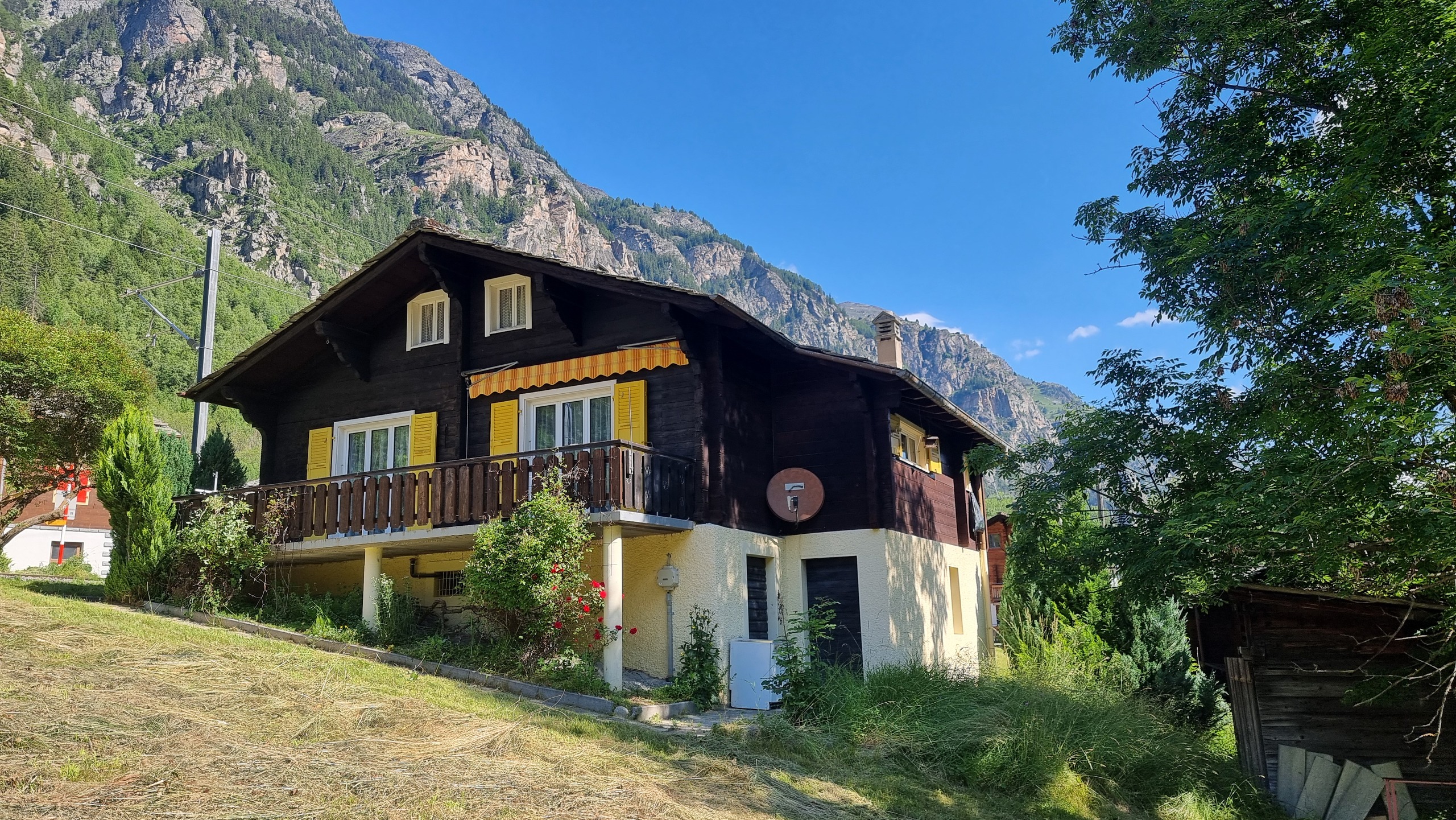 Berghaus mit Balkon in alpiner Landschaft